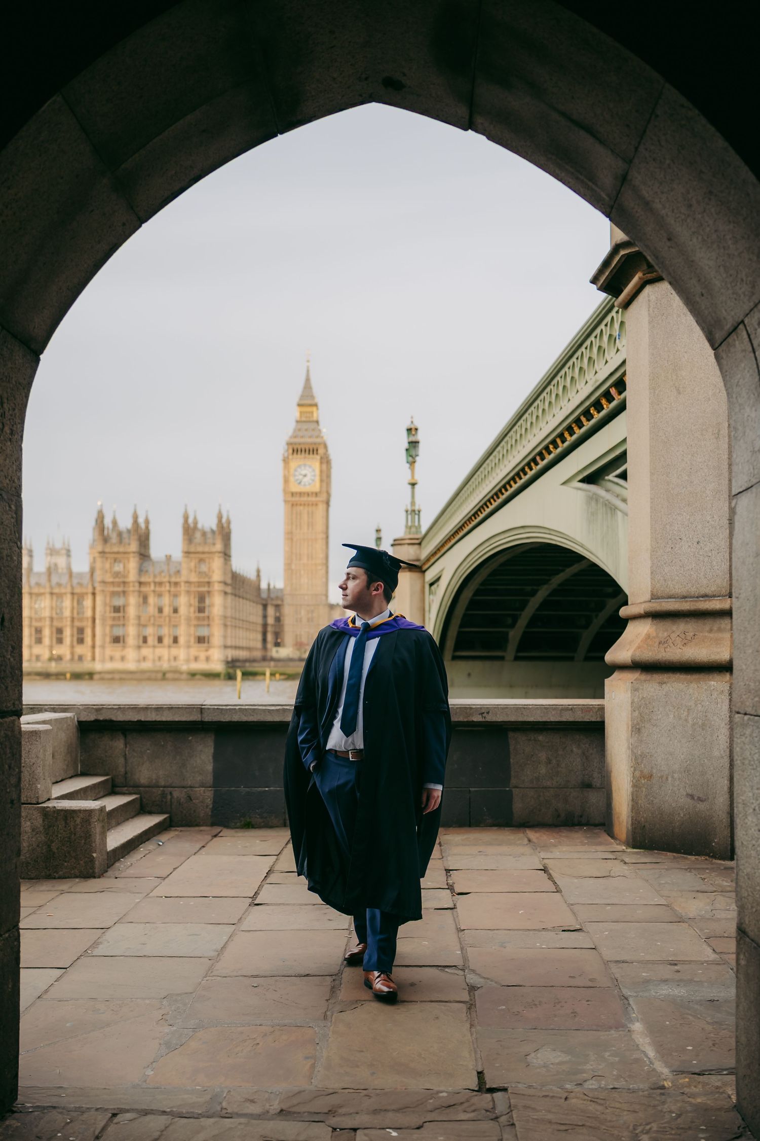 Graduation portrait under Westminster Bridge arches framing Big Ben, photographed in central London by London photographer @lyfphotos