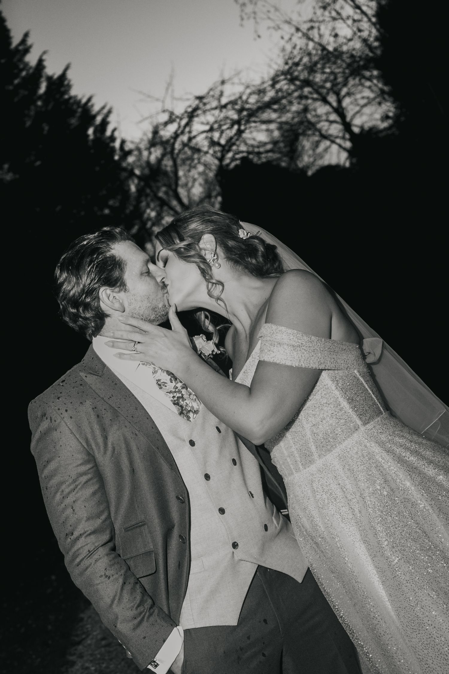 “Black and white candid kiss between the couple at South Farm Royston, captured by a UK London wedding photographer.”