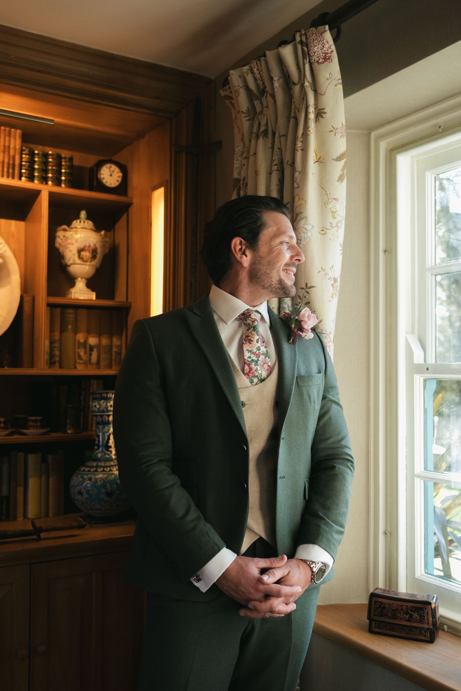 “Groom getting ready by the window at South Farm Royston, captured by a UK London wedding photographer.” @lyfphotos
