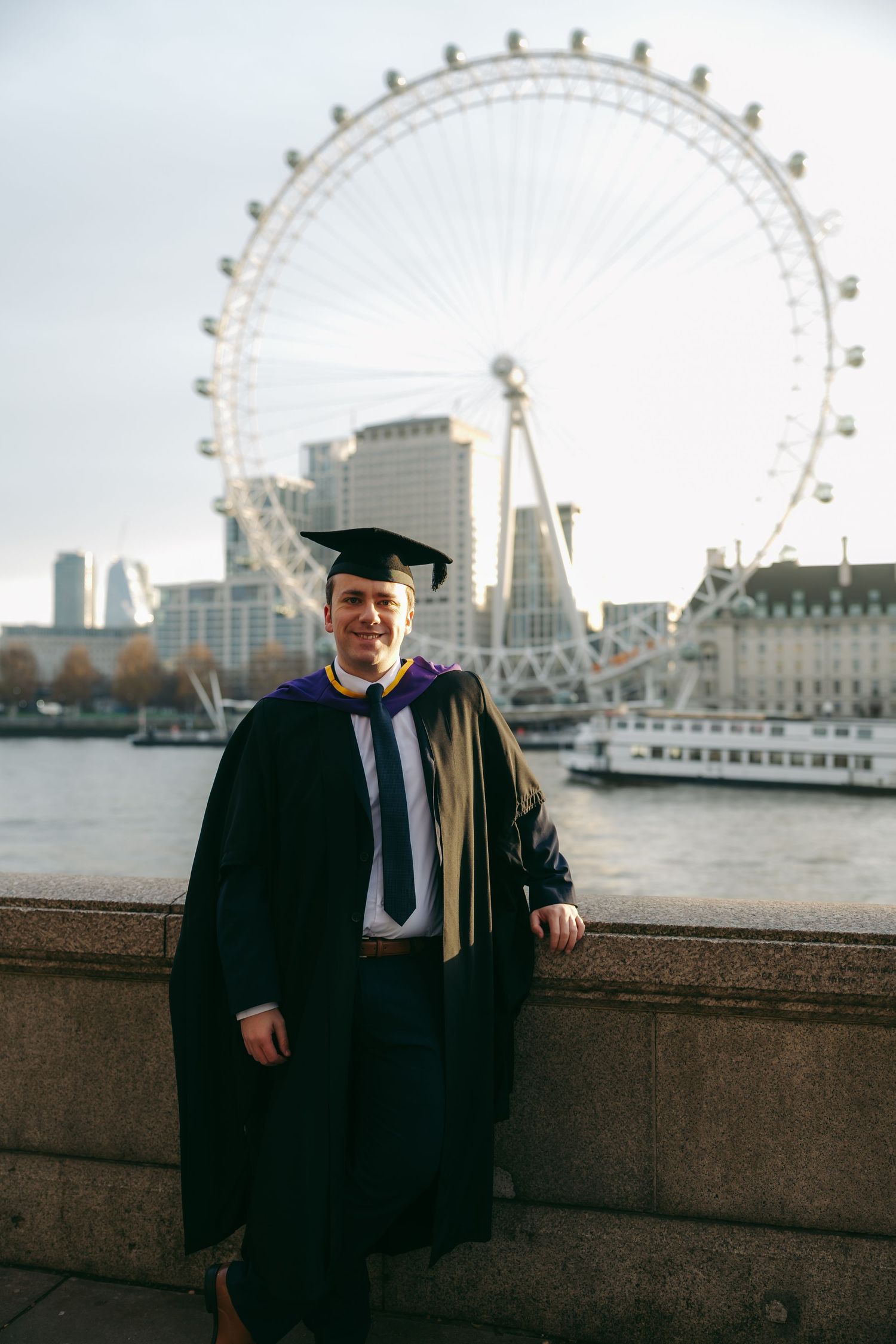Graduation portraits on the South Bank with the London Eye behind, photographed by London photographer @lyfphotos in central London