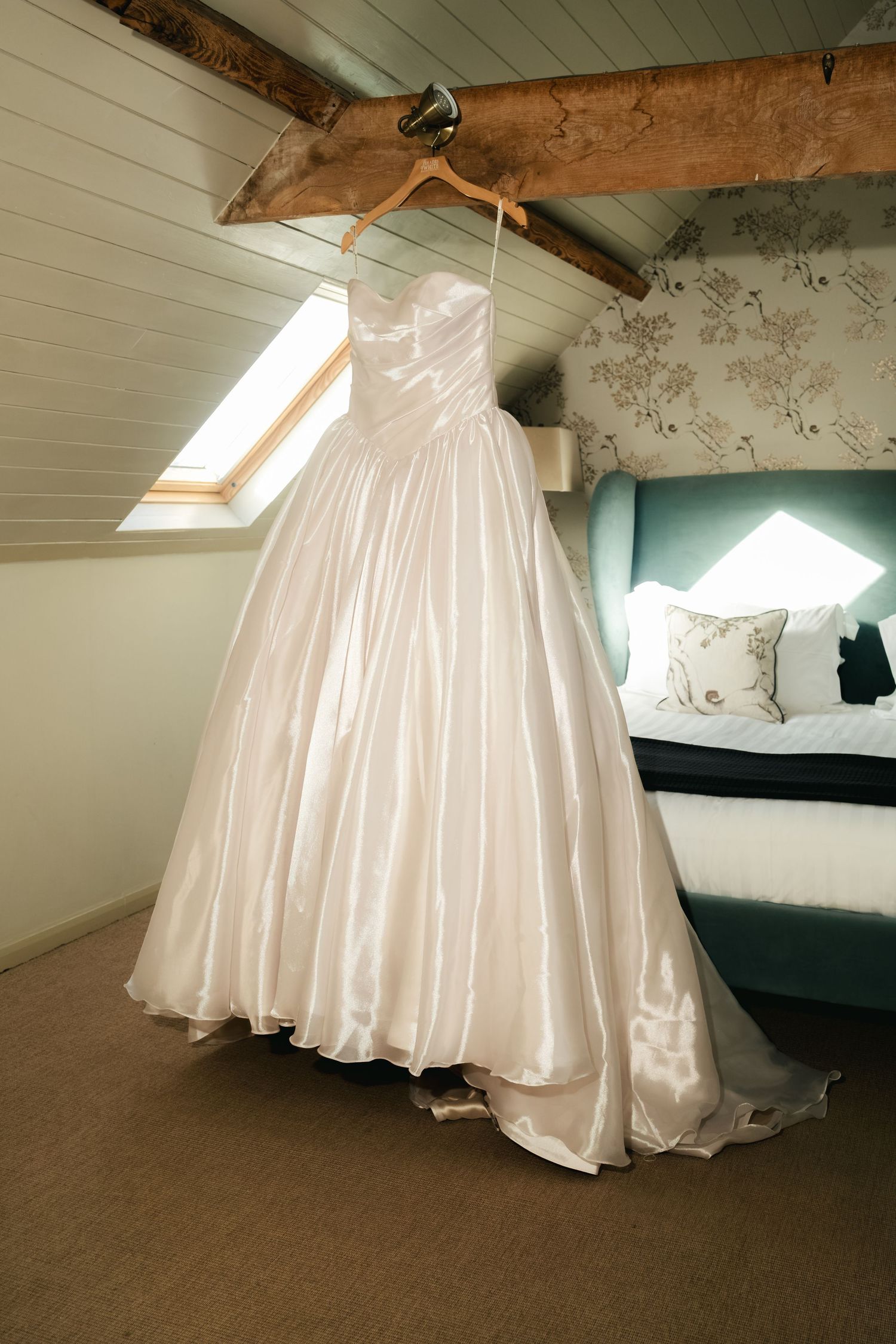 Bridal wedding dress hanging before the ceremony at South Farm Royston, captured by a UK London wedding photographer.