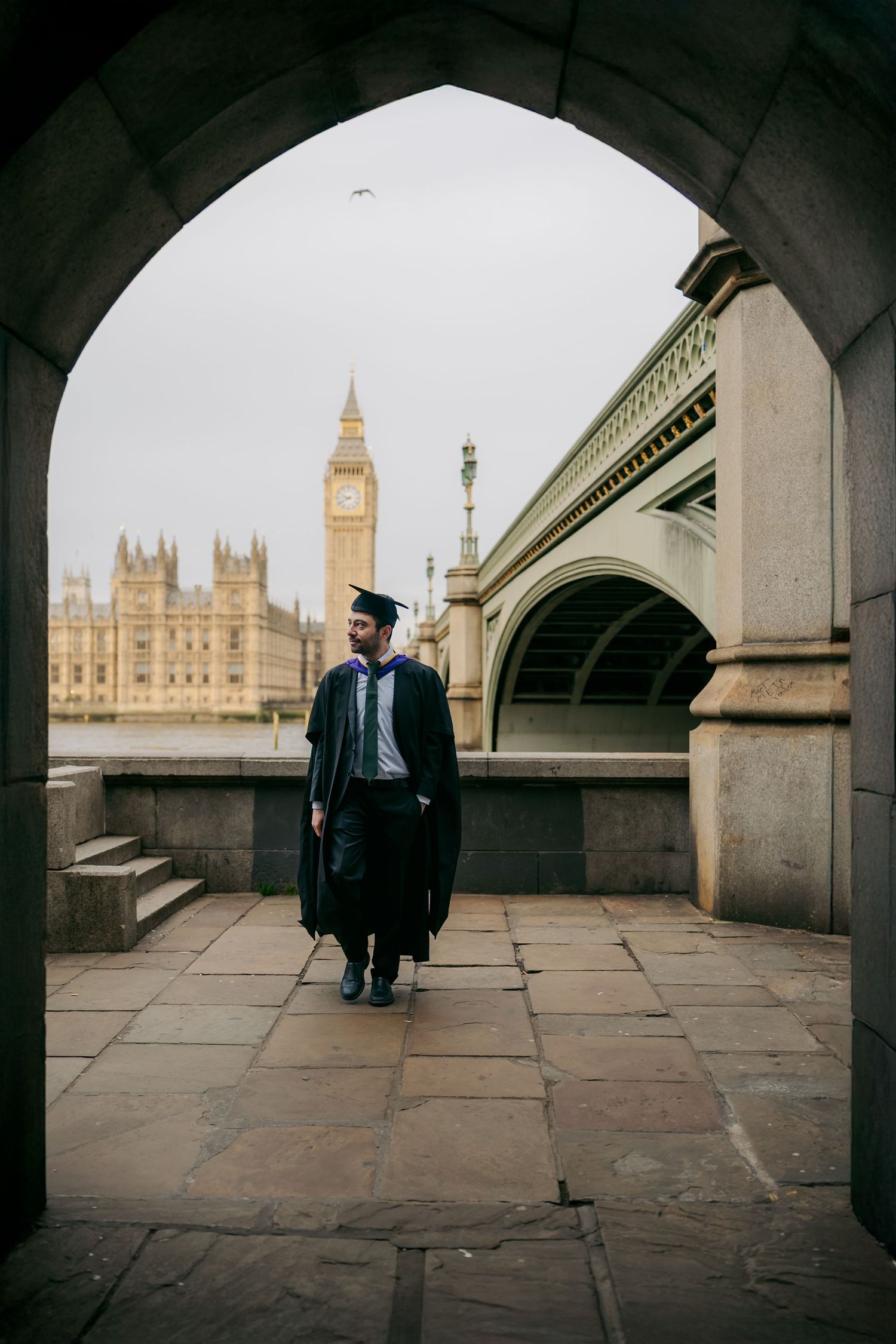 Graduation portrait under Westminster Bridge arches framing Big Ben, photographed in central London by London photographer @lyfphotos