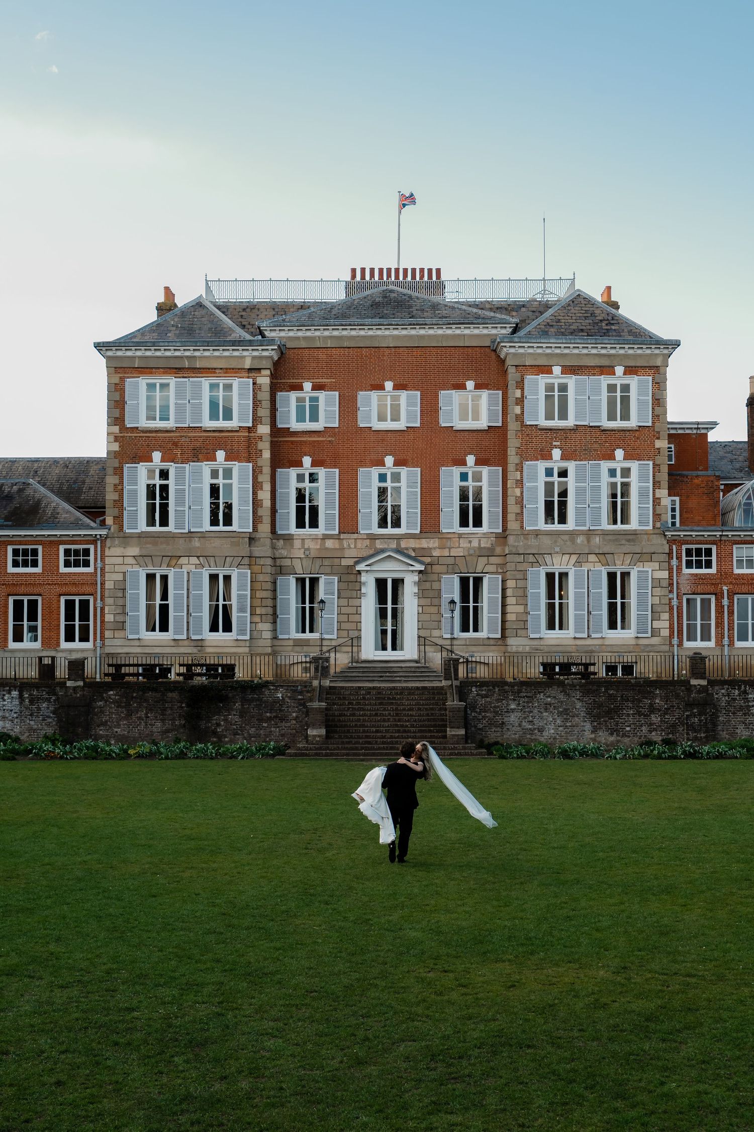 Bride and groom walking through York House gardens in spring