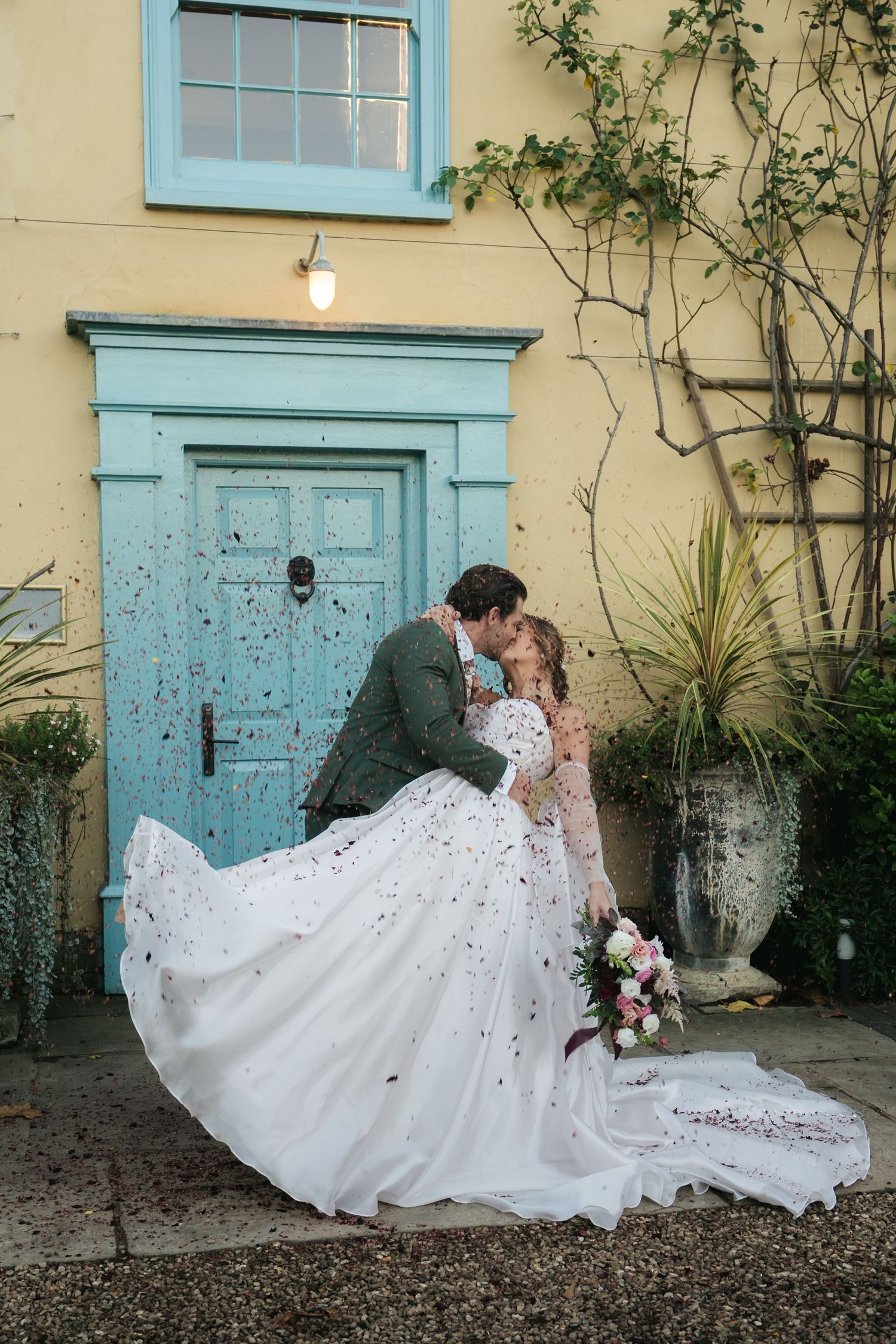 “Bride and groom celebrating under falling confetti, joyful wedding moment at South Farm Royston, captured by a UK London wedding photograph