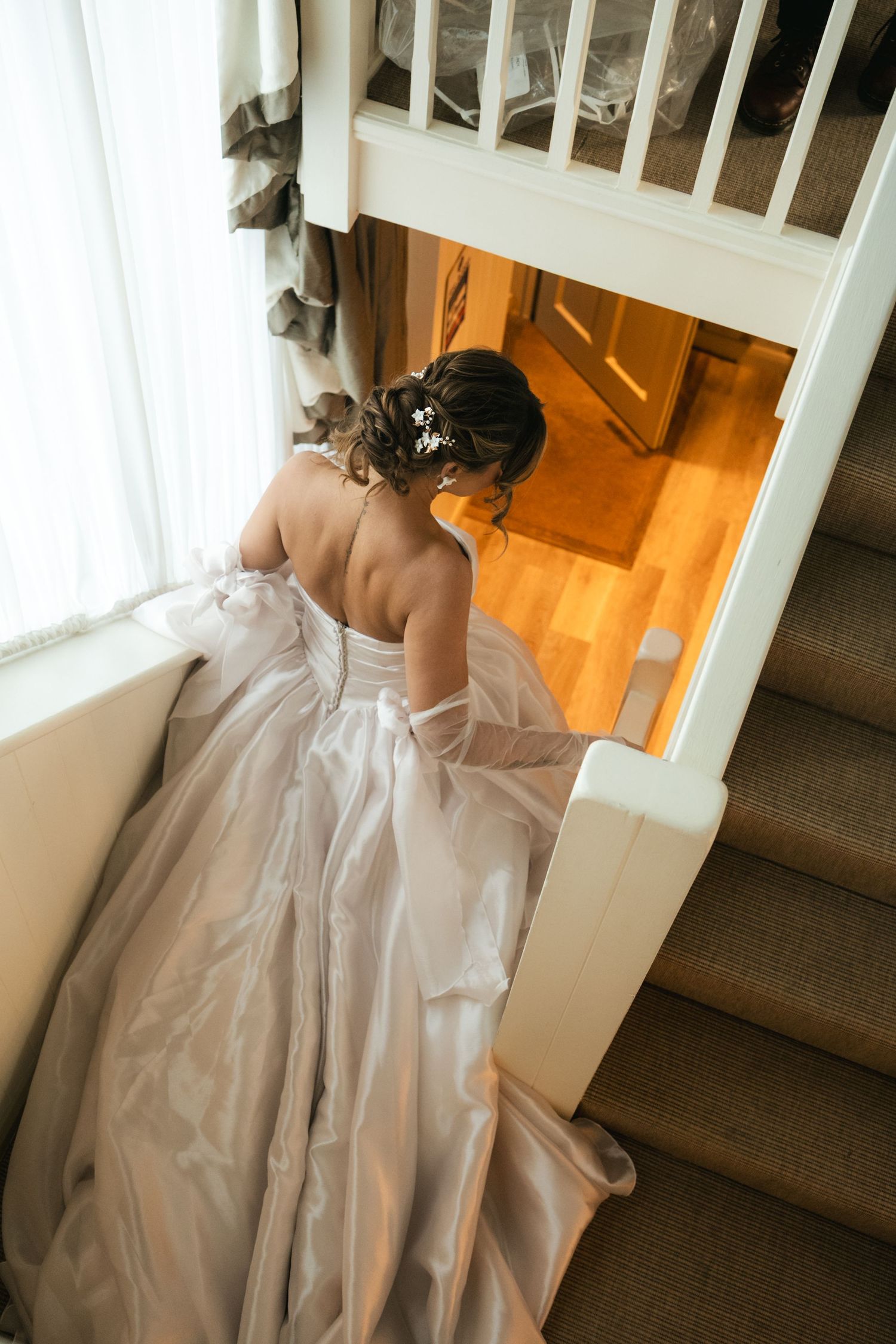 Bride walking down the staircase before her wedding at South Farm Royston, captured by a UK London wedding photographer. @lyfphotos