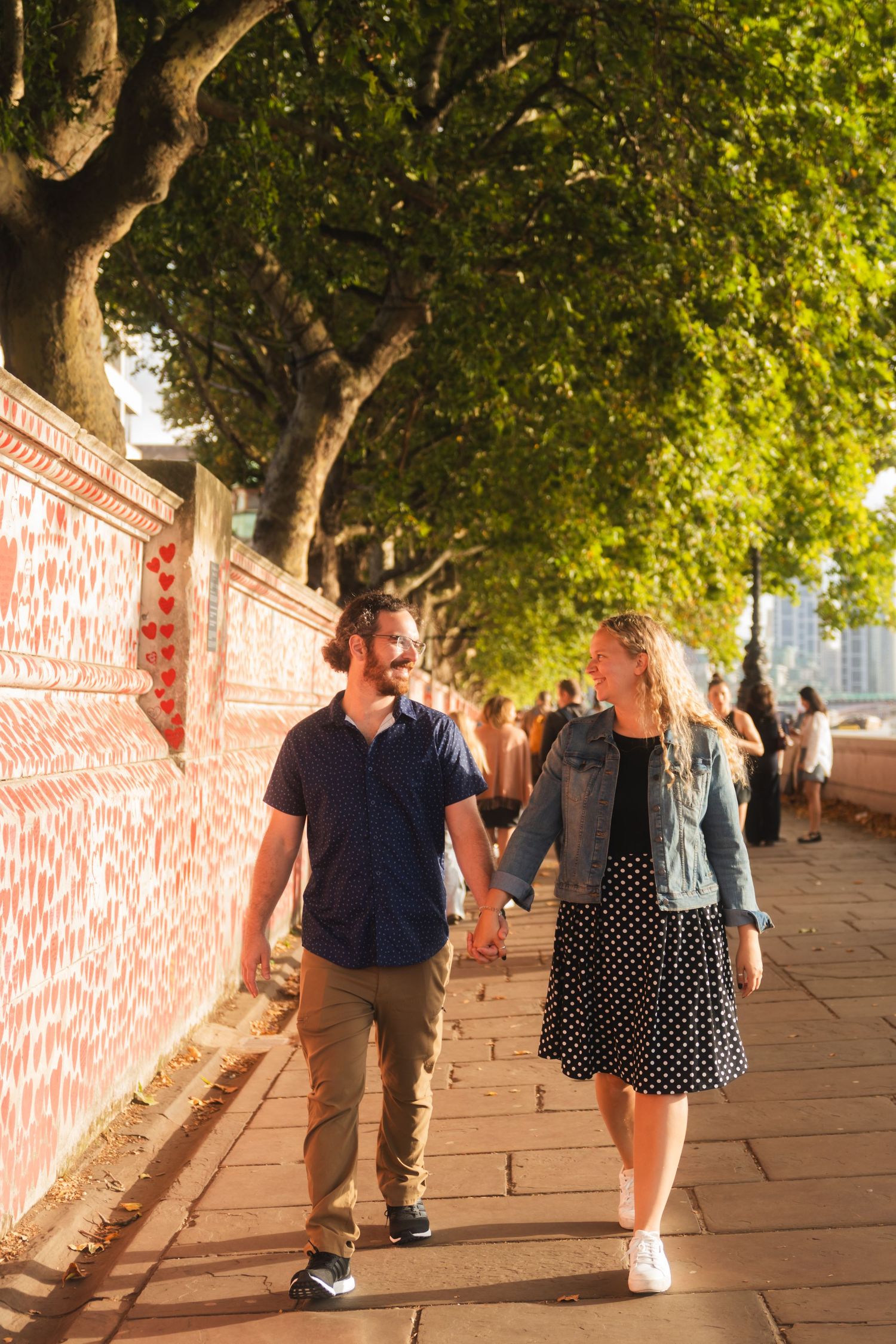 Couple walking near the Thames during a London photo session captured by UK Photographer @lyfphotos