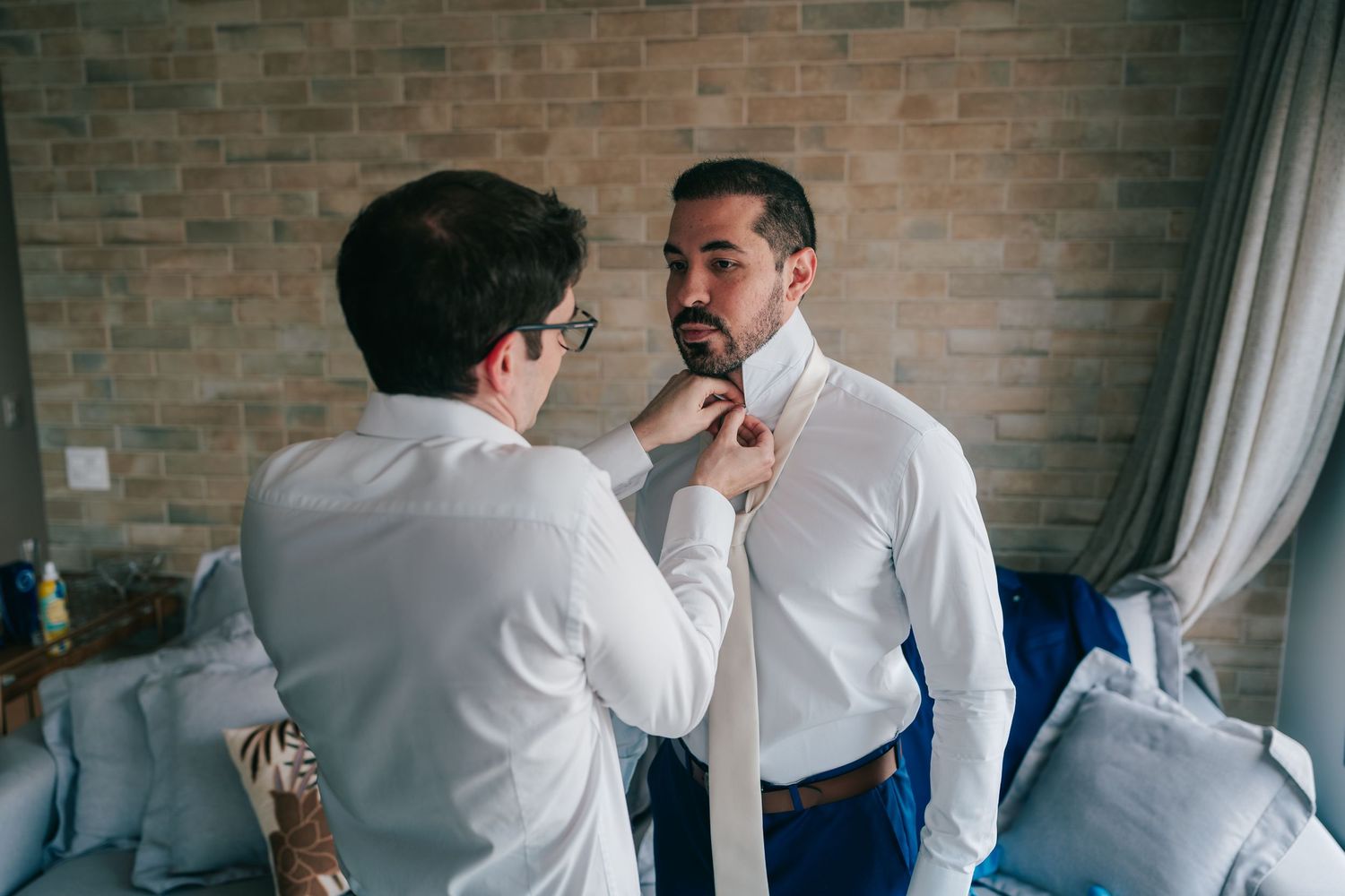 Groom getting ready with father and friends before Botânico Quintal wedding in São Paulo, Brazil.