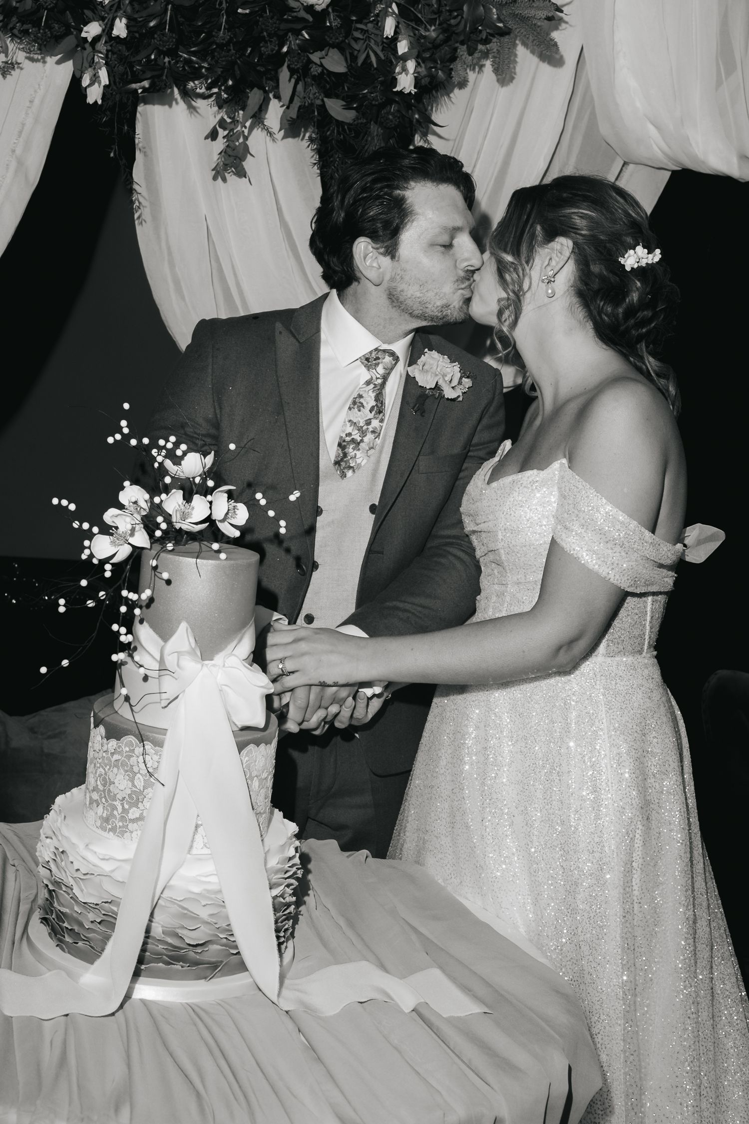 “Couple cutting their wedding cake at South Farm Royston, captured by a UK London wedding photographer.”