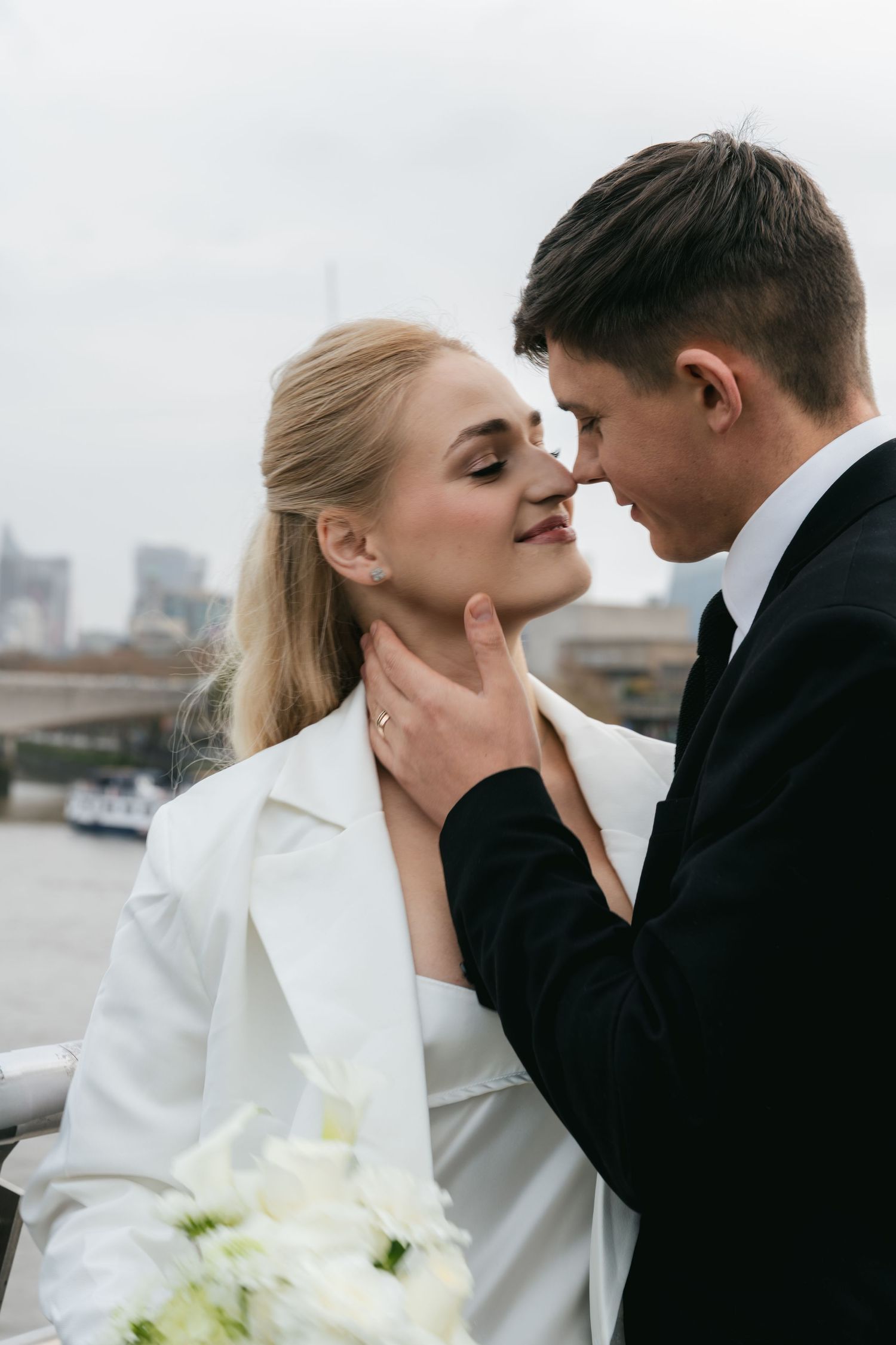 “Couple on Hungerford Bridge with London skyline views during a Central London photoshoot.”