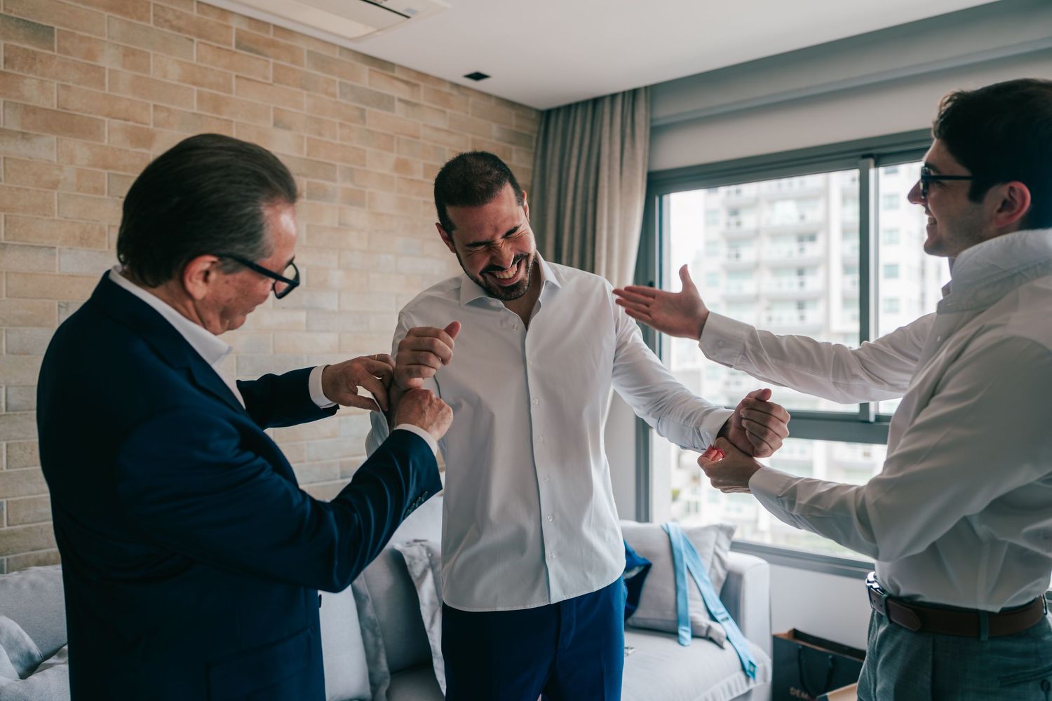 Groom getting ready with father and friends before Botânico Quintal wedding in São Paulo, Brazil.
