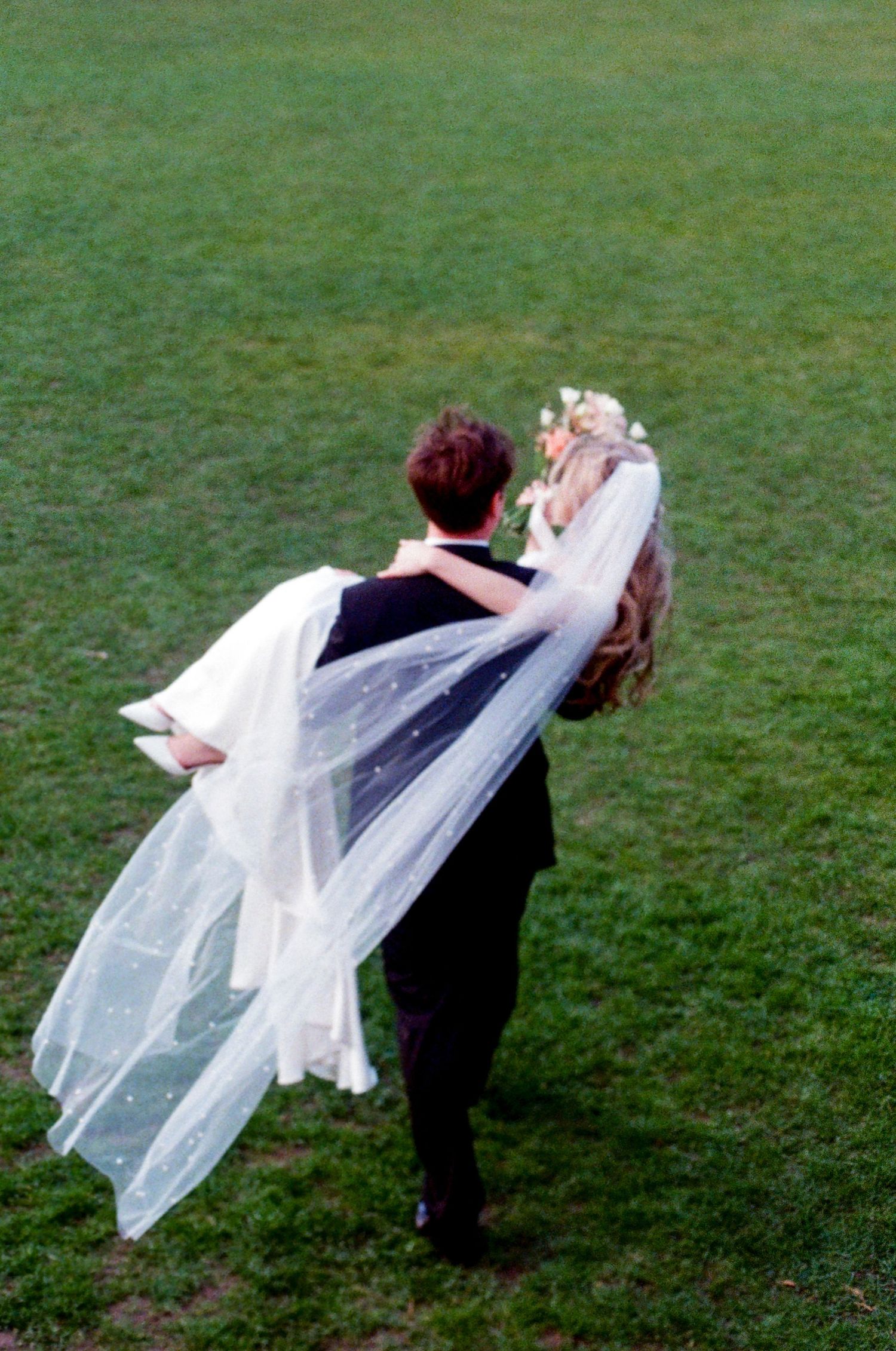 Bride and groom walking through York House gardens in spring