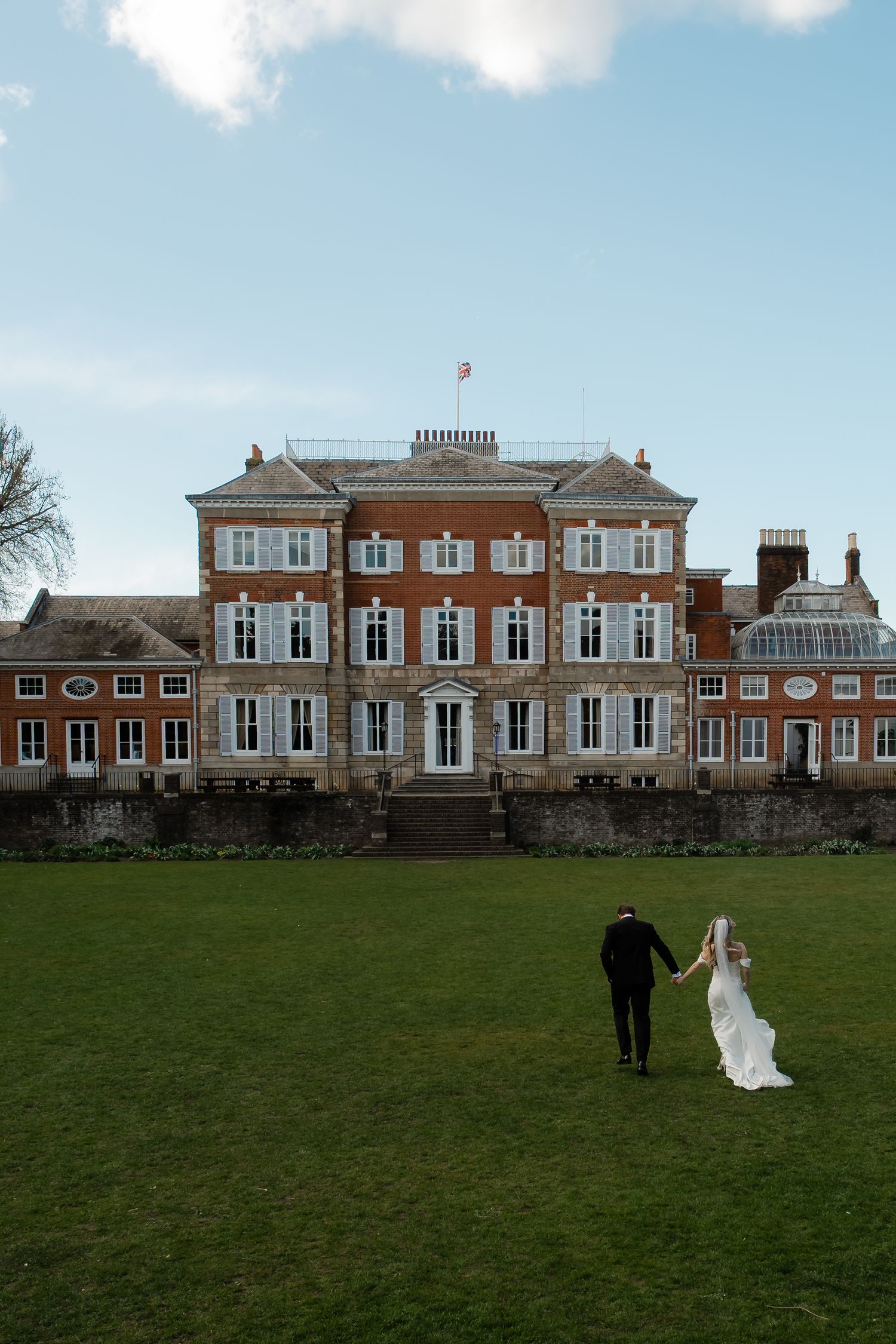 Bride and groom walking through York House gardens in spring