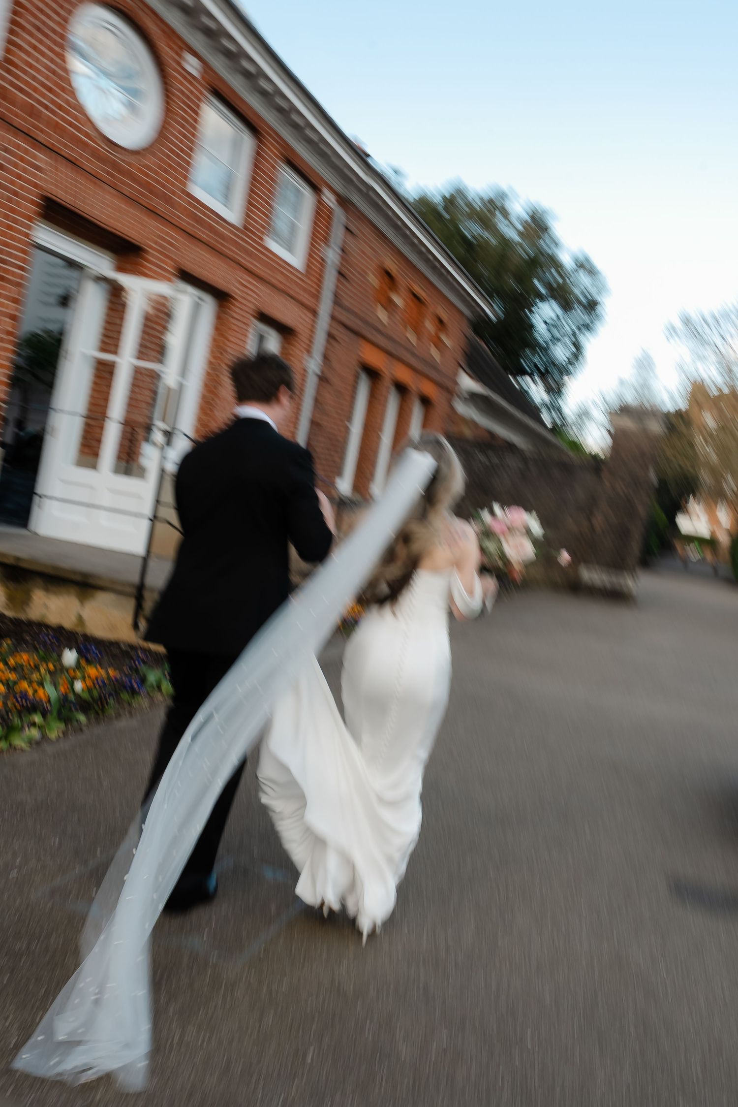 Bride and groom walking through York House gardens in spring