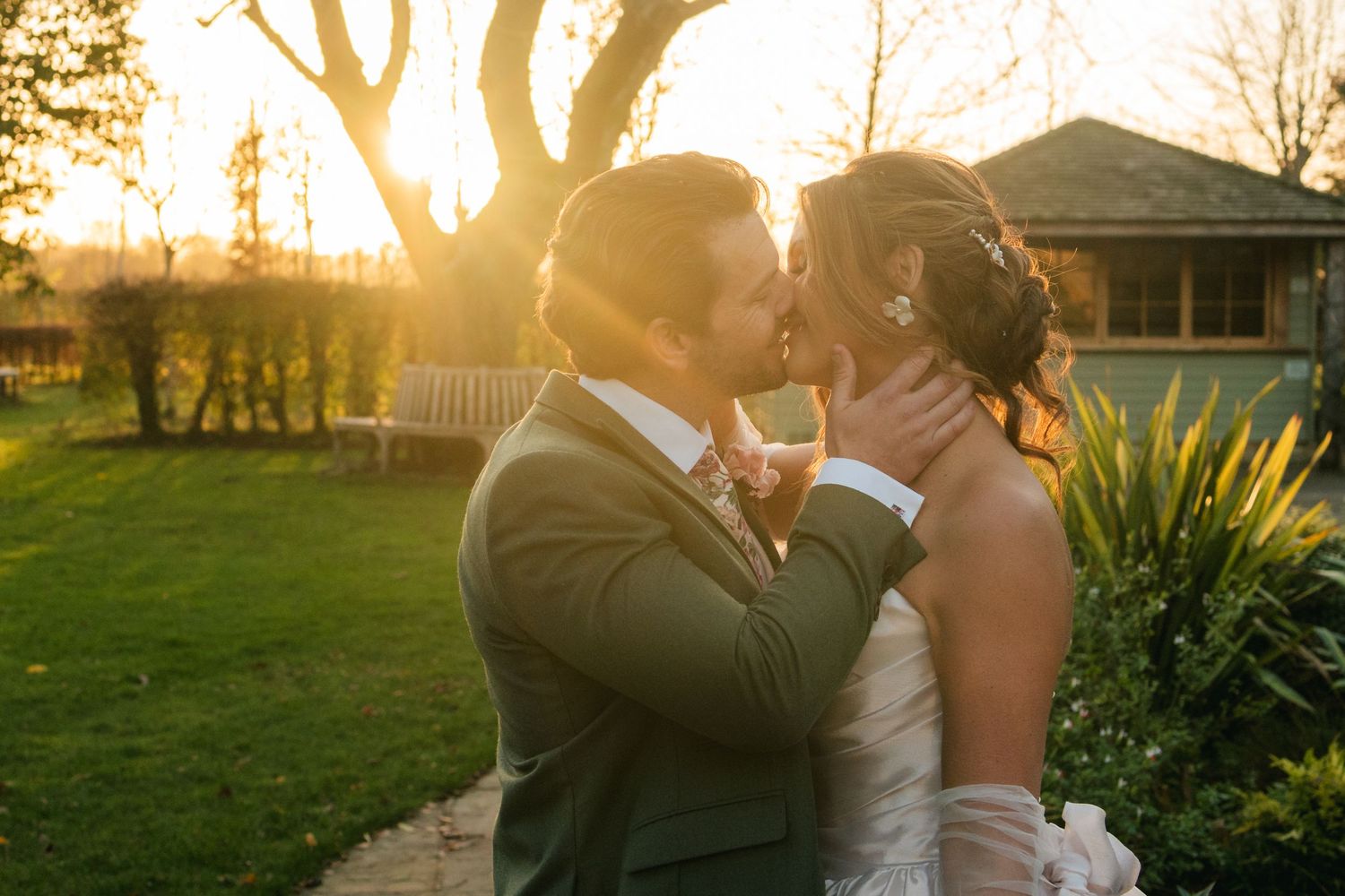 “Couple kissing at sunset at South Farm Royston, captured by a UK London wedding photographer.”