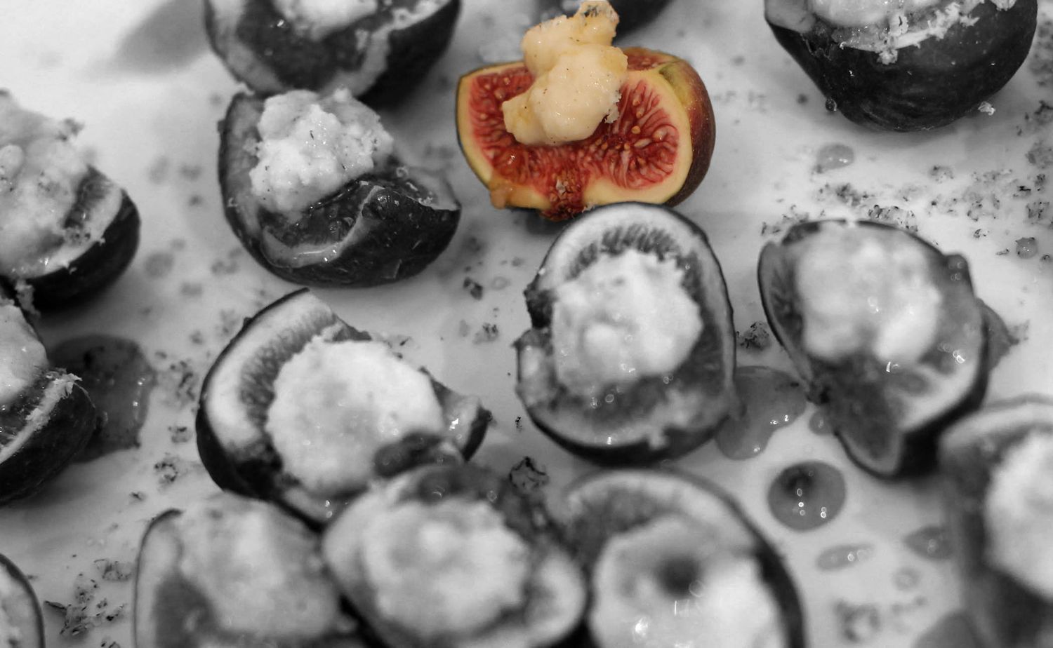 Fresh oysters on ice with garnishes in black and white photography.
