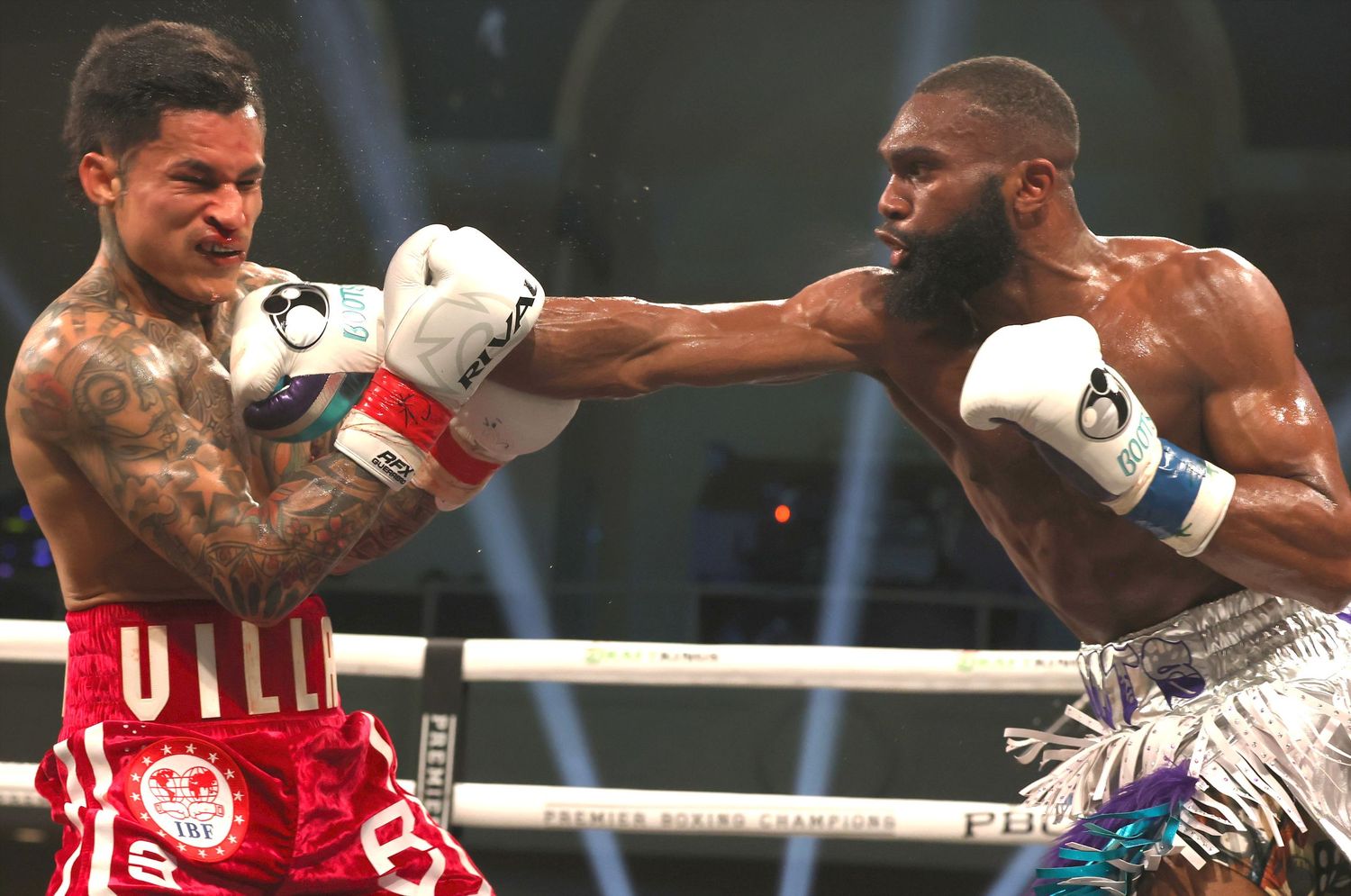 Professional boxers trading punches during an intense championship fight.