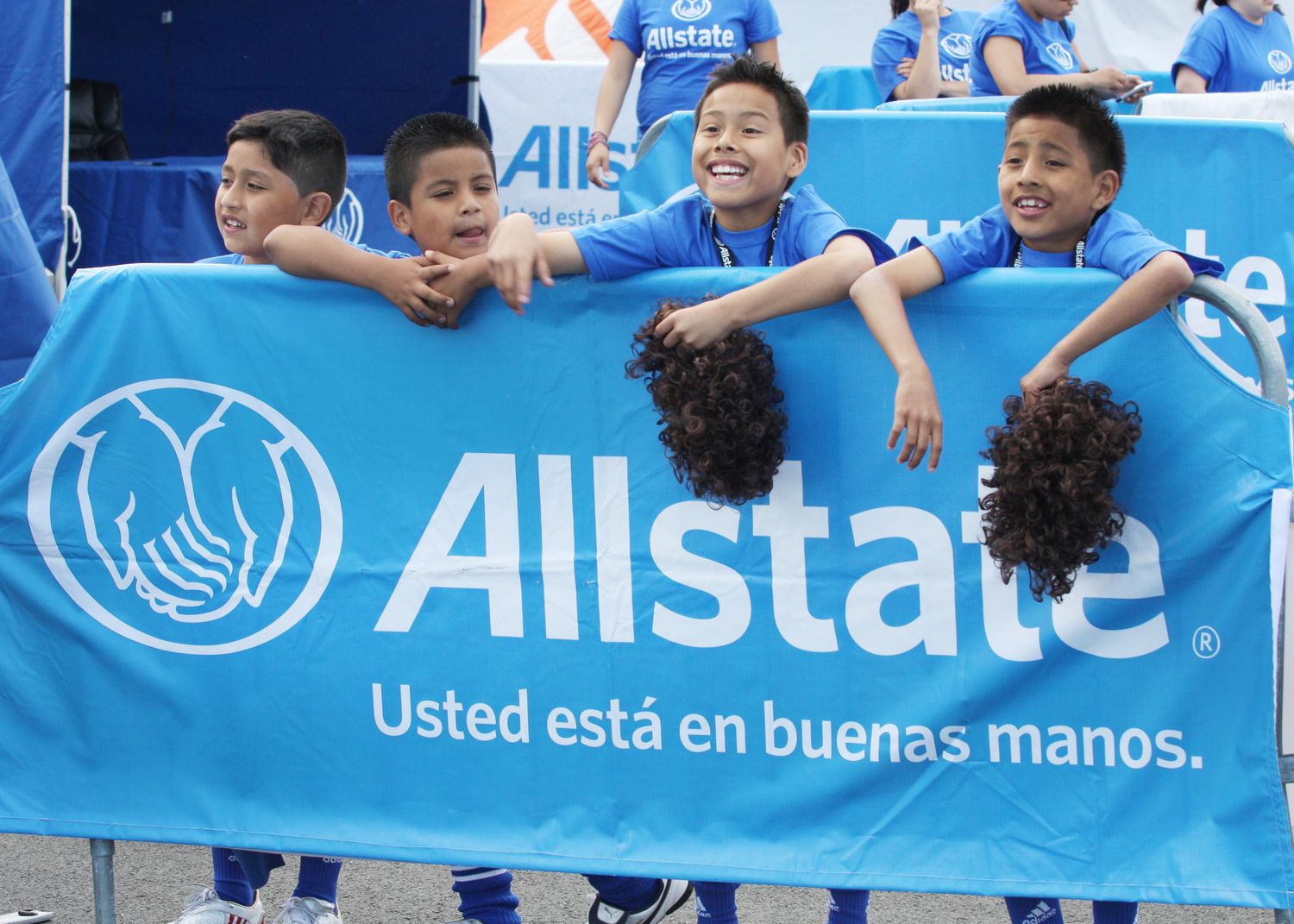 Row of blue Allstate insurance banners displayed at an outdoor event.