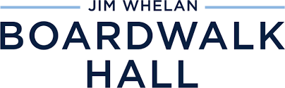 Vintage-style boardwalk sign with blue text and decorative lines displaying 'Jim Whelan Boardwalk Hall'.