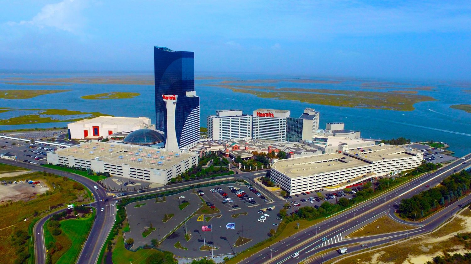 Panoramic coastal view of Atlantic City skyline with hotels and highways along the shoreline.