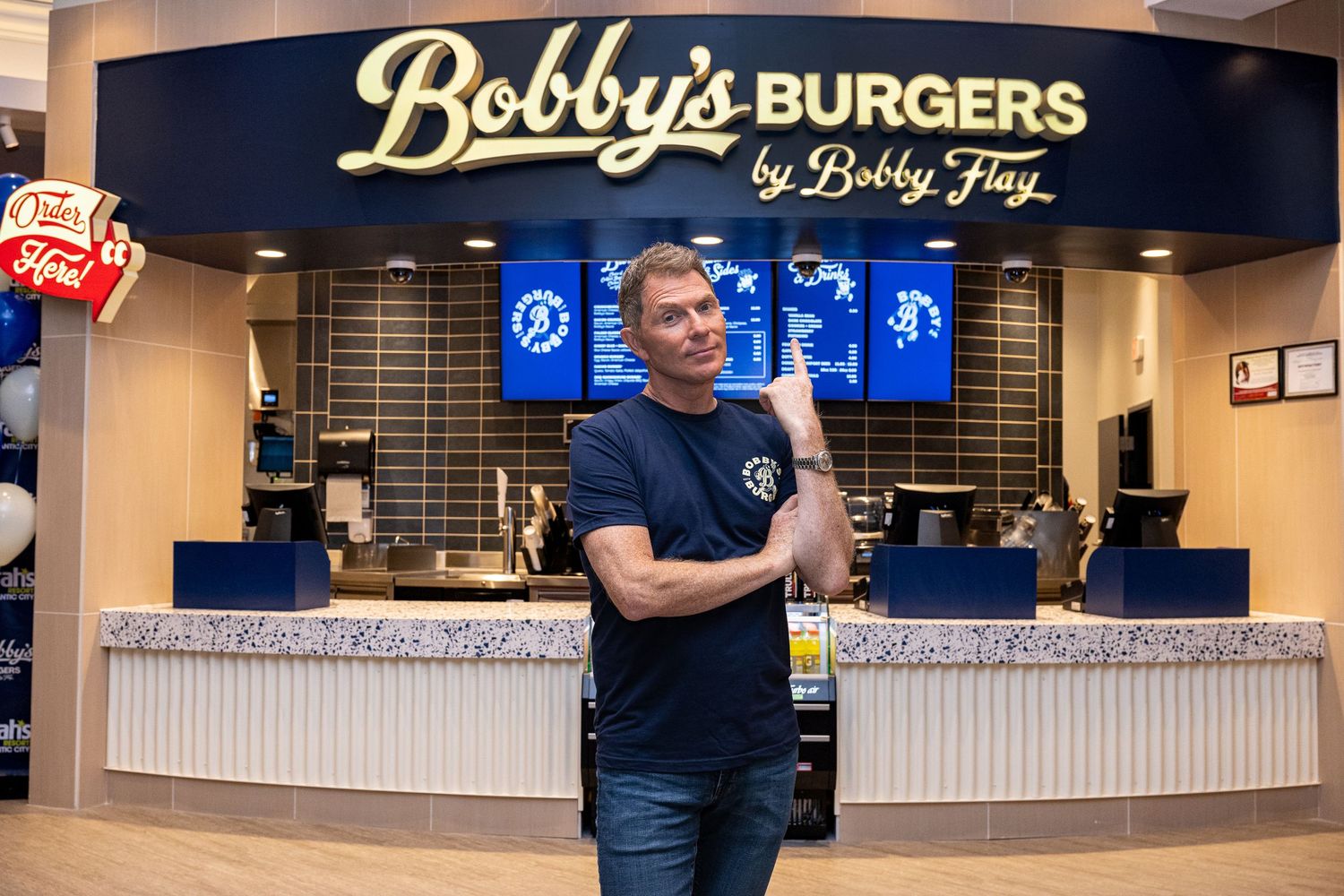 Bobby's Burgers restaurant storefront with illuminated signage and counter service area.
