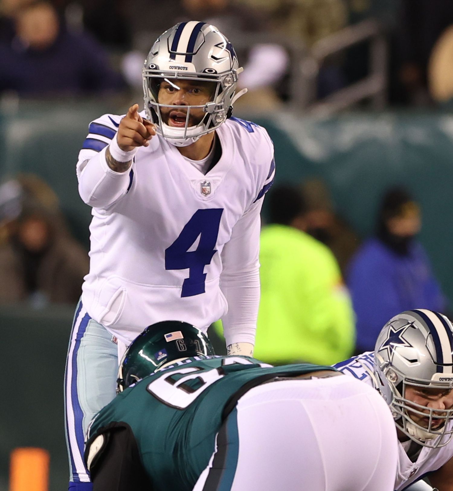 Dallas Cowboys quarterback signals at the line of scrimmage during game against Philadelphia Eagles.