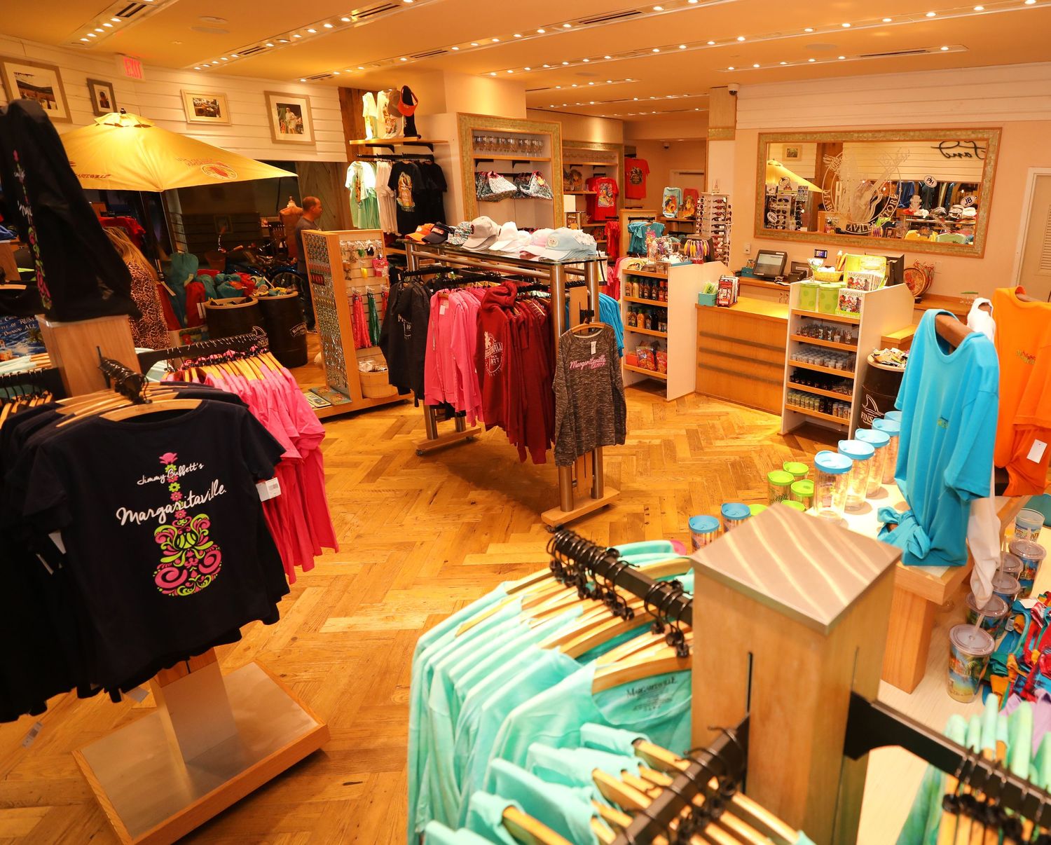 Retail store interior displaying colorful clothing and merchandise under warm lighting.