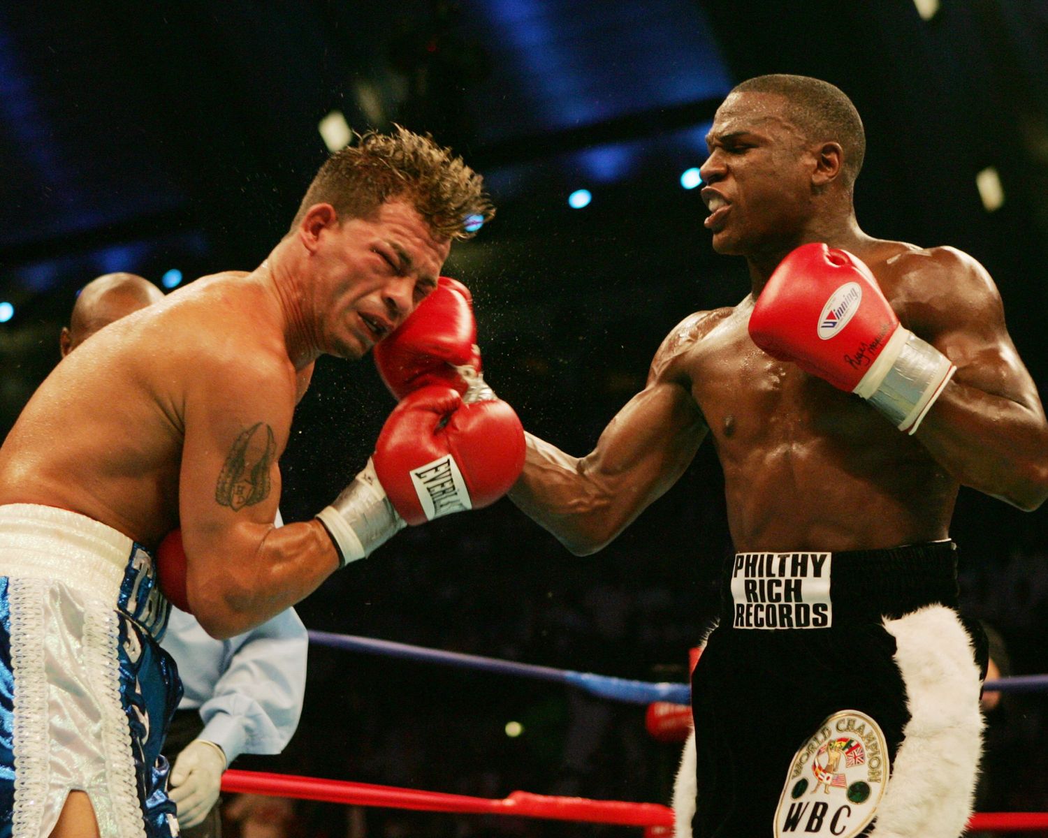 Two boxers exchanging powerful punches in a professional boxing match.