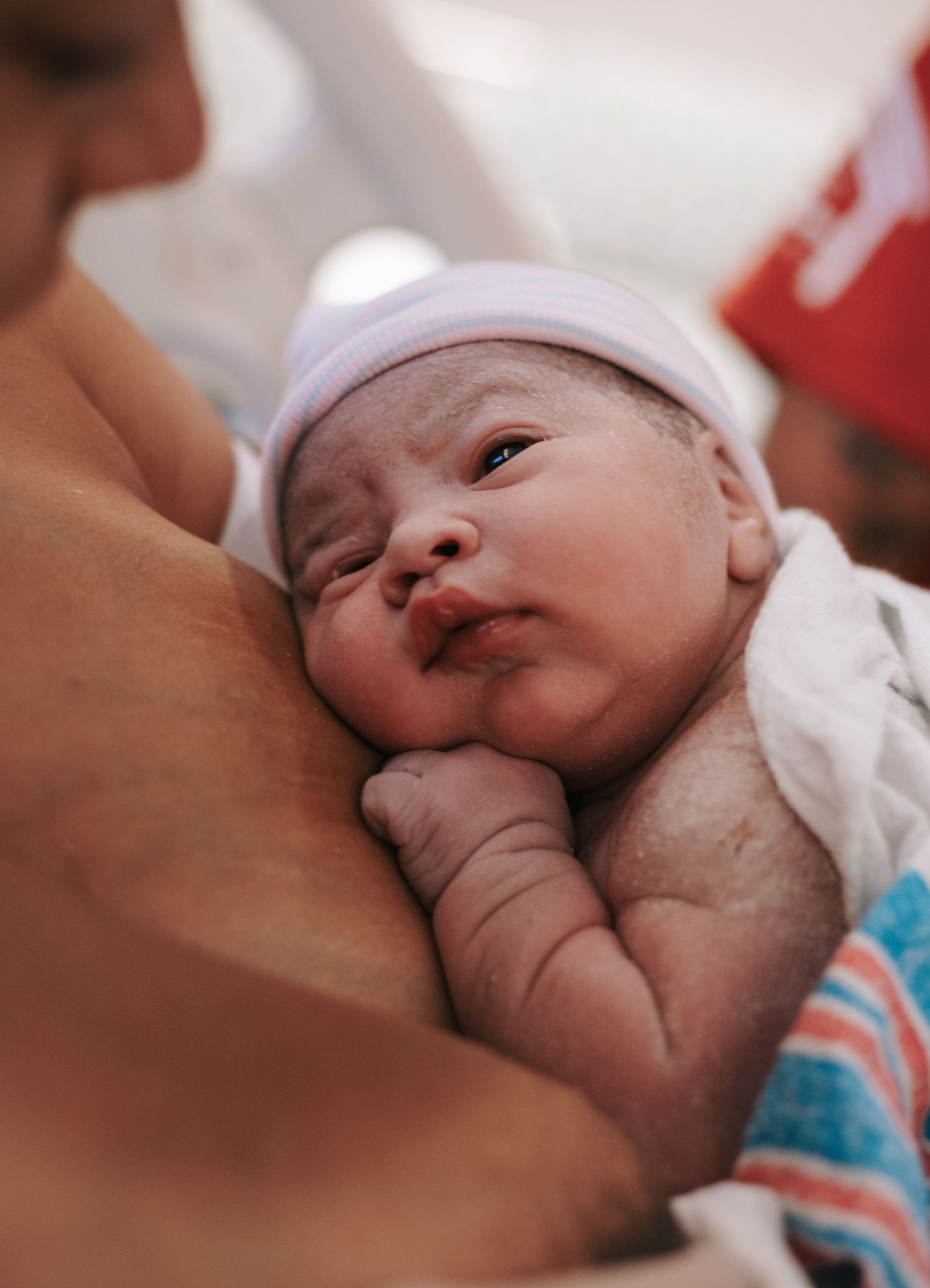 Close-up shots of a newborn baby's face showing different expressions while nursing.