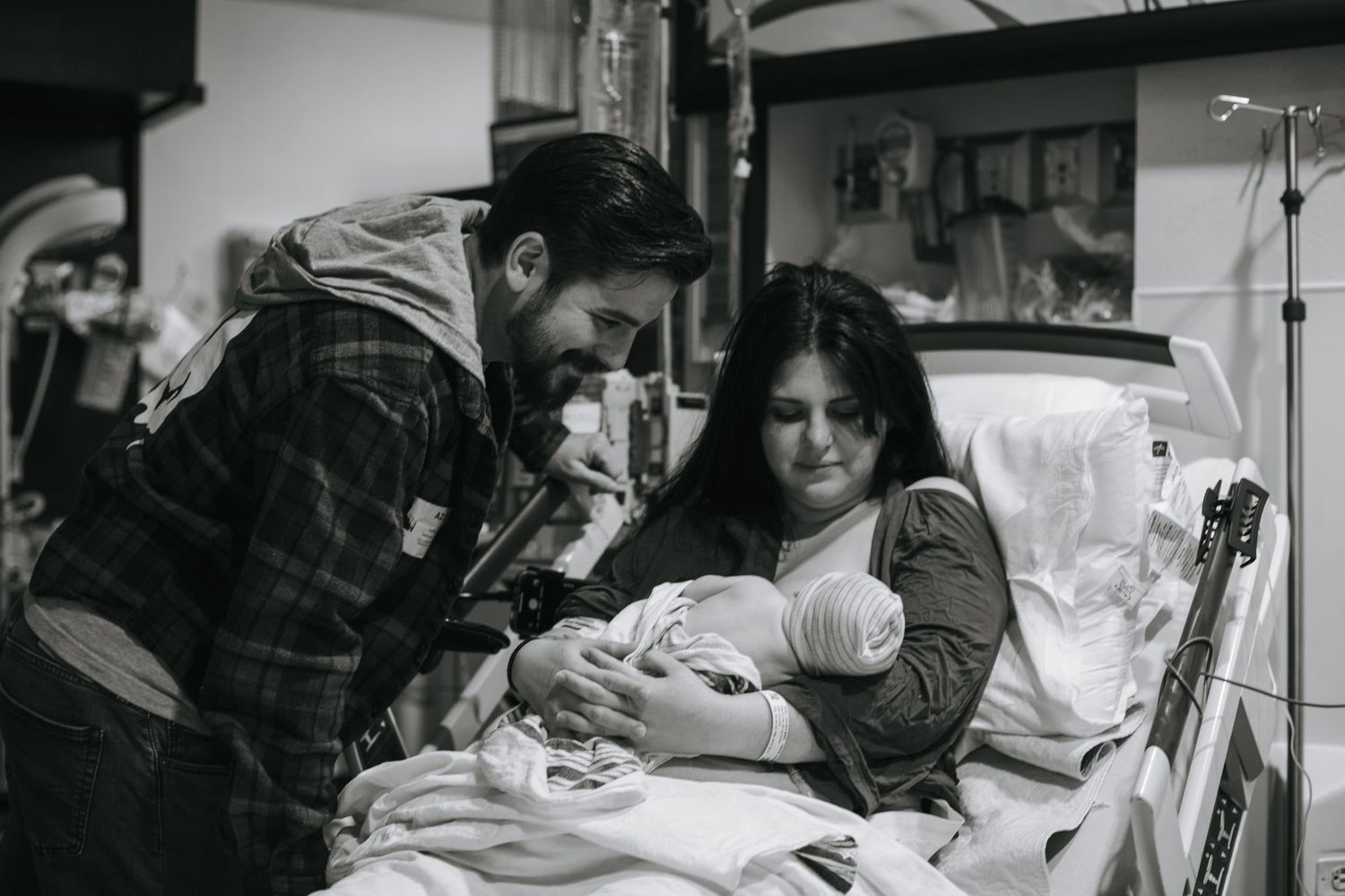 A black and white photo capturing a moment in the delivery room.