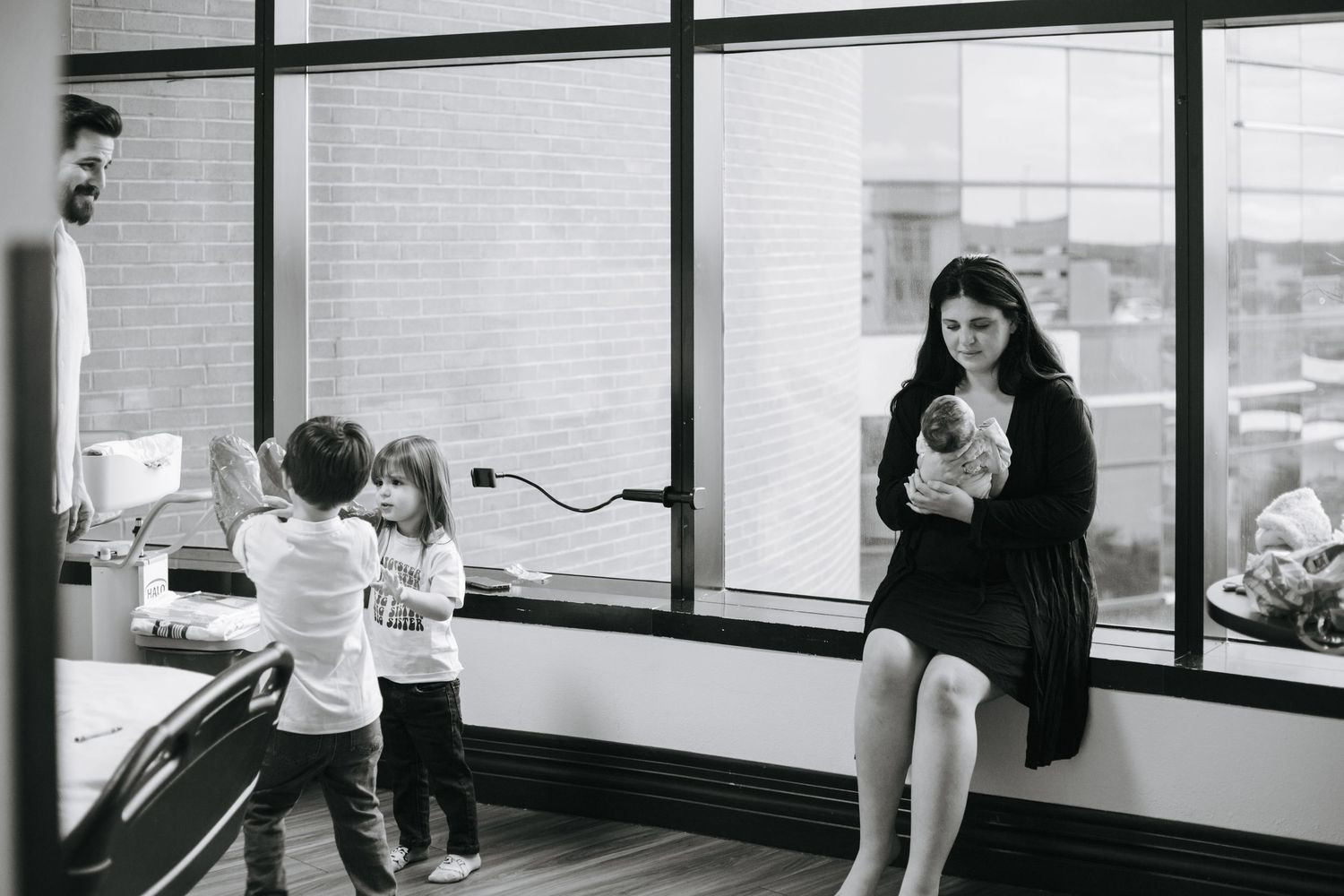 Wide view of a modern room with large windows during a newborn photo session.