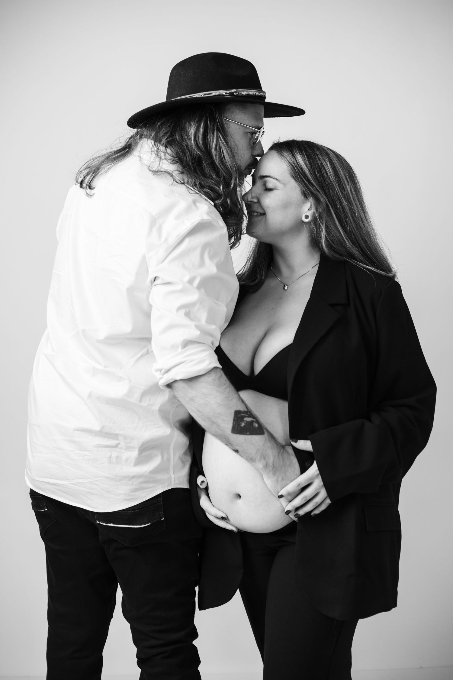 A romantic black and white photo series showing intimate moments between a couple in western attire.
