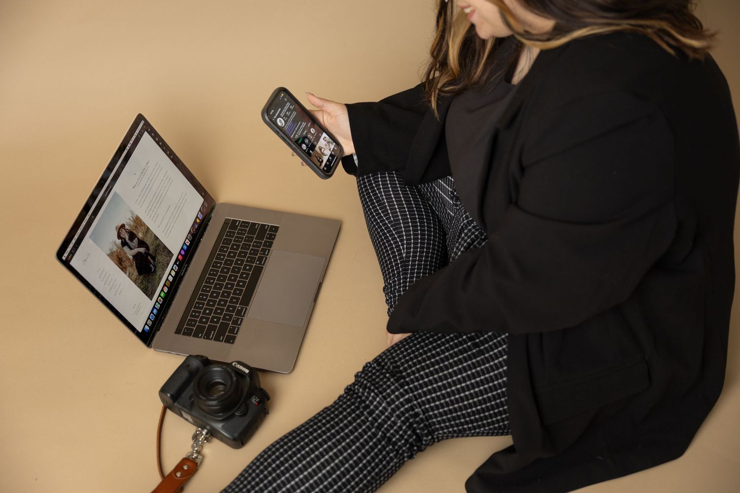 Professional photography equipment and laptops arranged on a desk.
