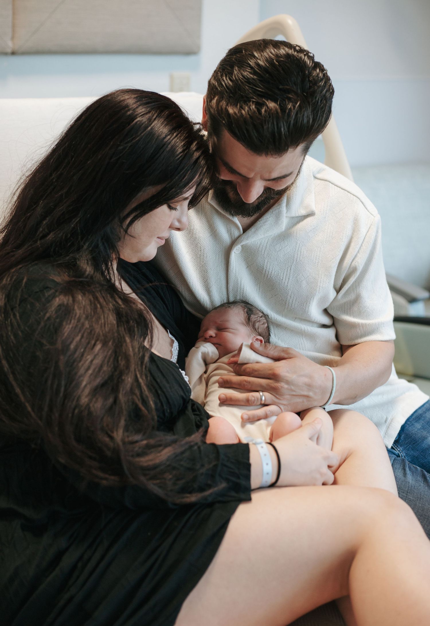 Artistic maternity photography series showing tender moments between expectant parents.