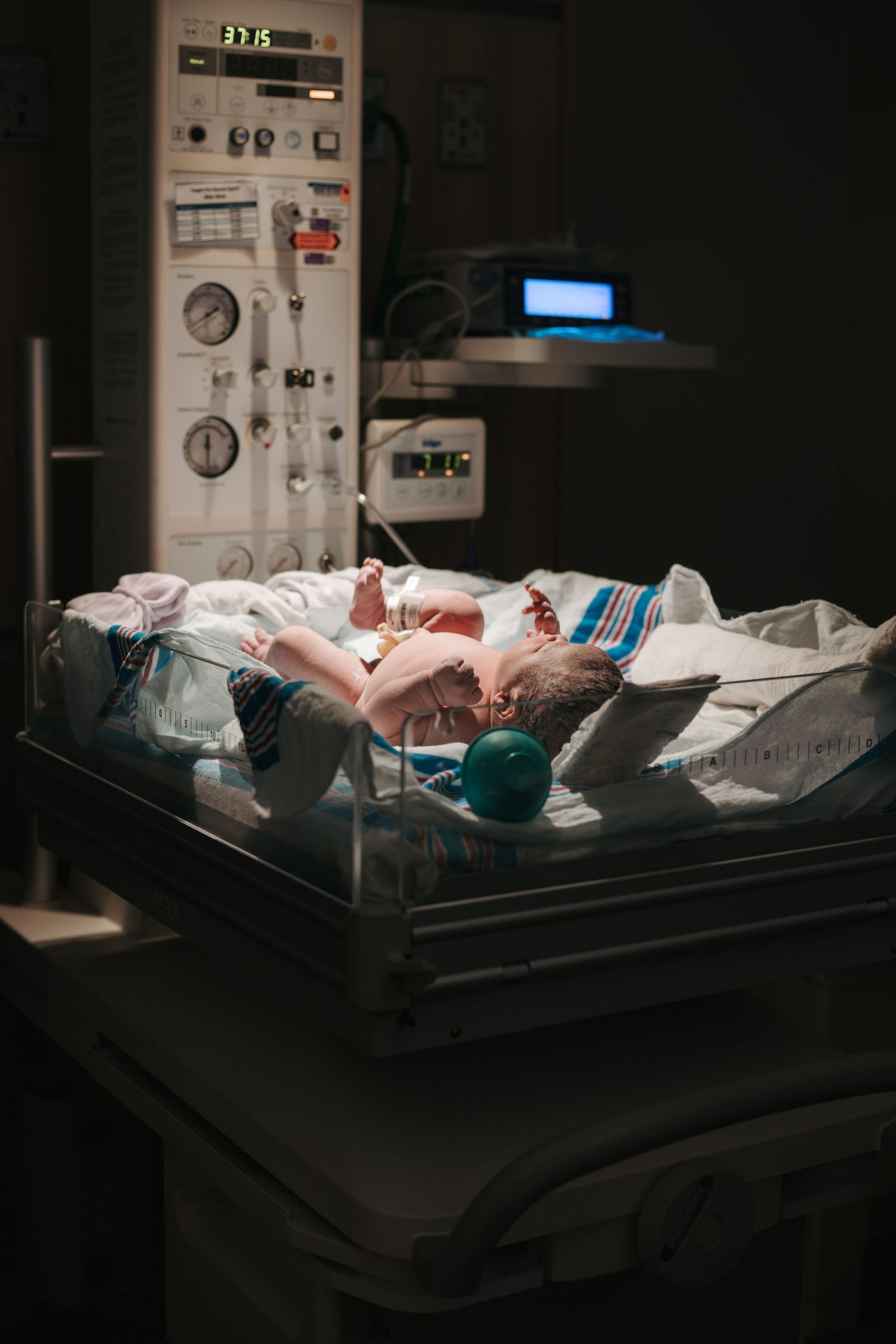 Monitoring equipment and medical devices in a darkened hospital nursery care unit.