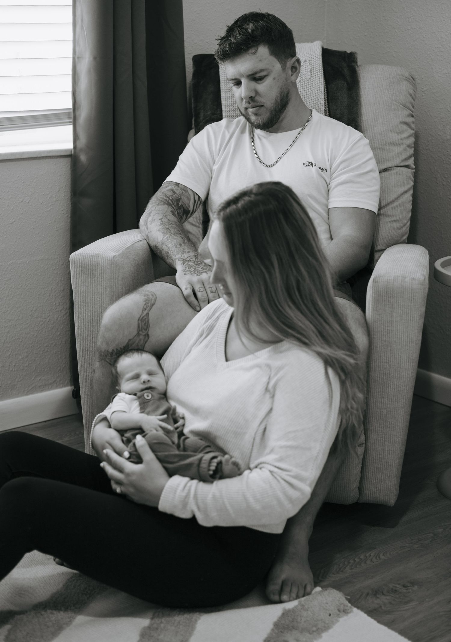 A series of intimate black and white maternity photos showing a couple bonding on a couch.