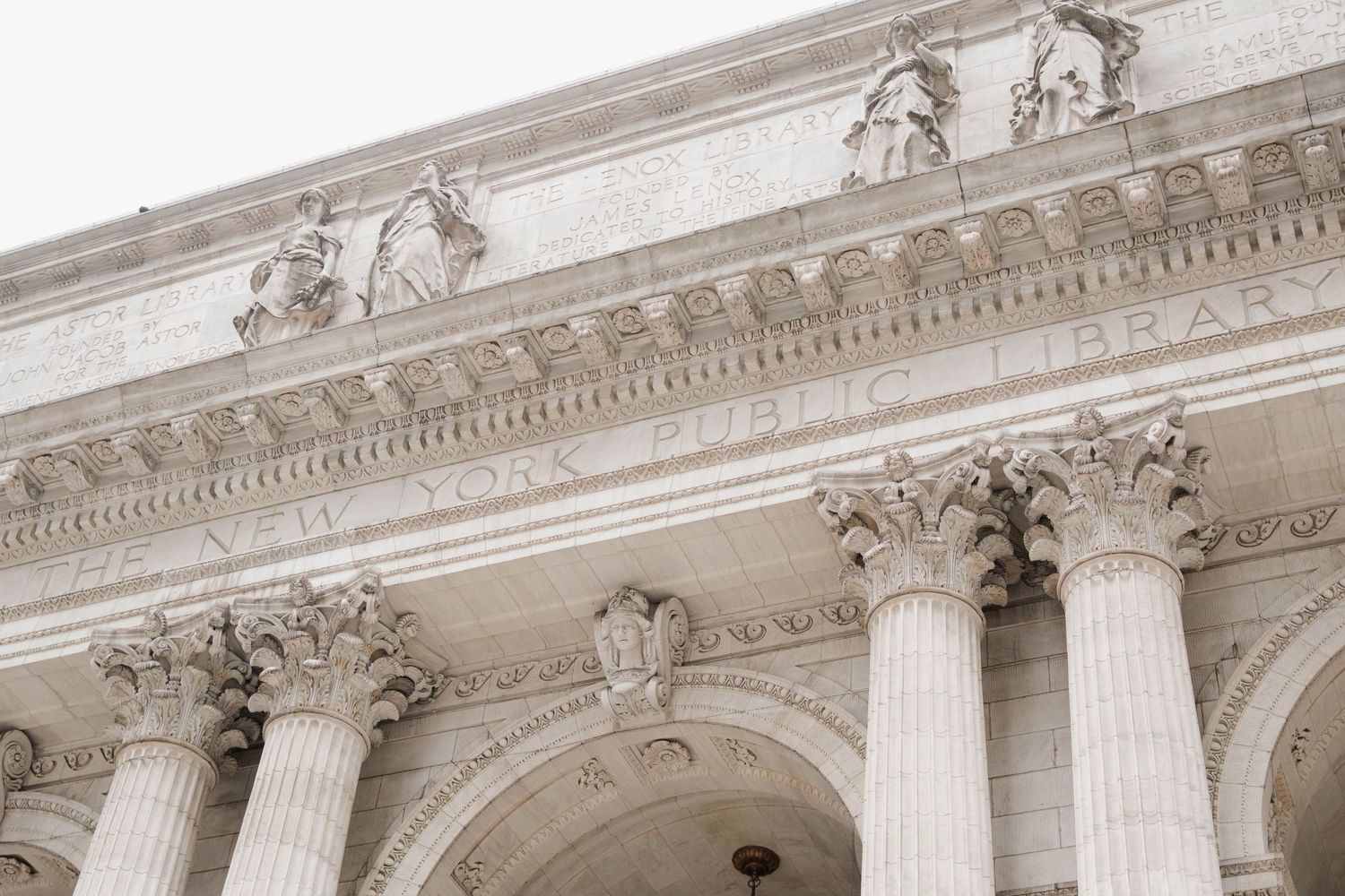 Ornate facade of the New York Public Library featuring Corinthian columns and detailed stone carvings.
