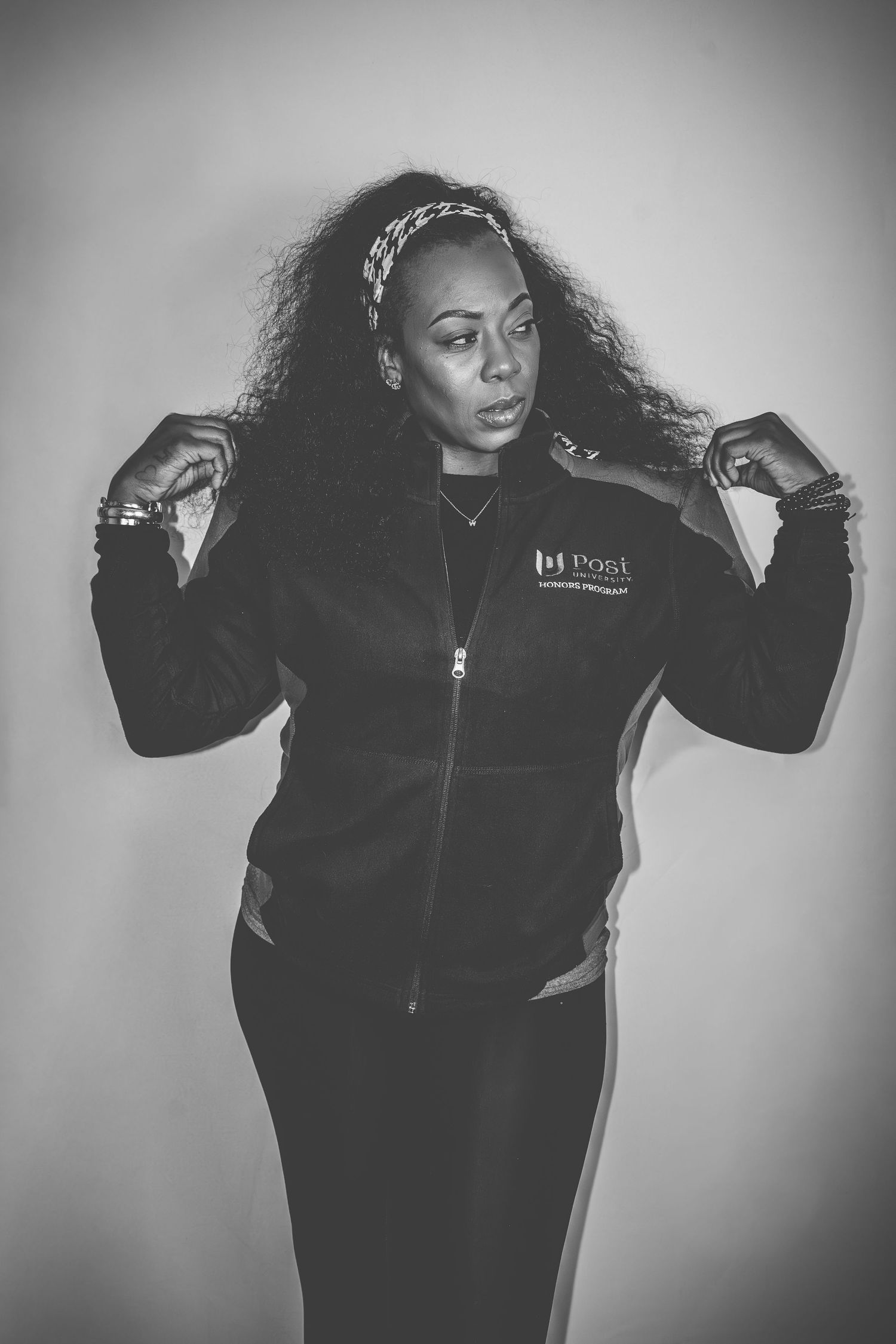 Artistic black and white portrait series showing dynamic poses in a black jacket against a plain background.
