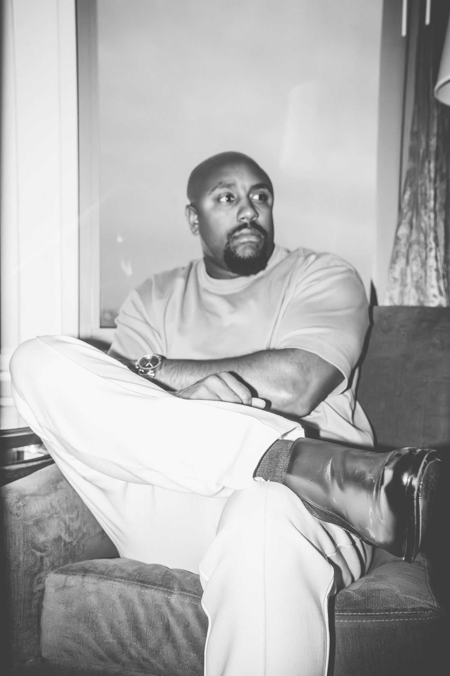 A casual portrait of someone relaxing on a couch in monochrome.