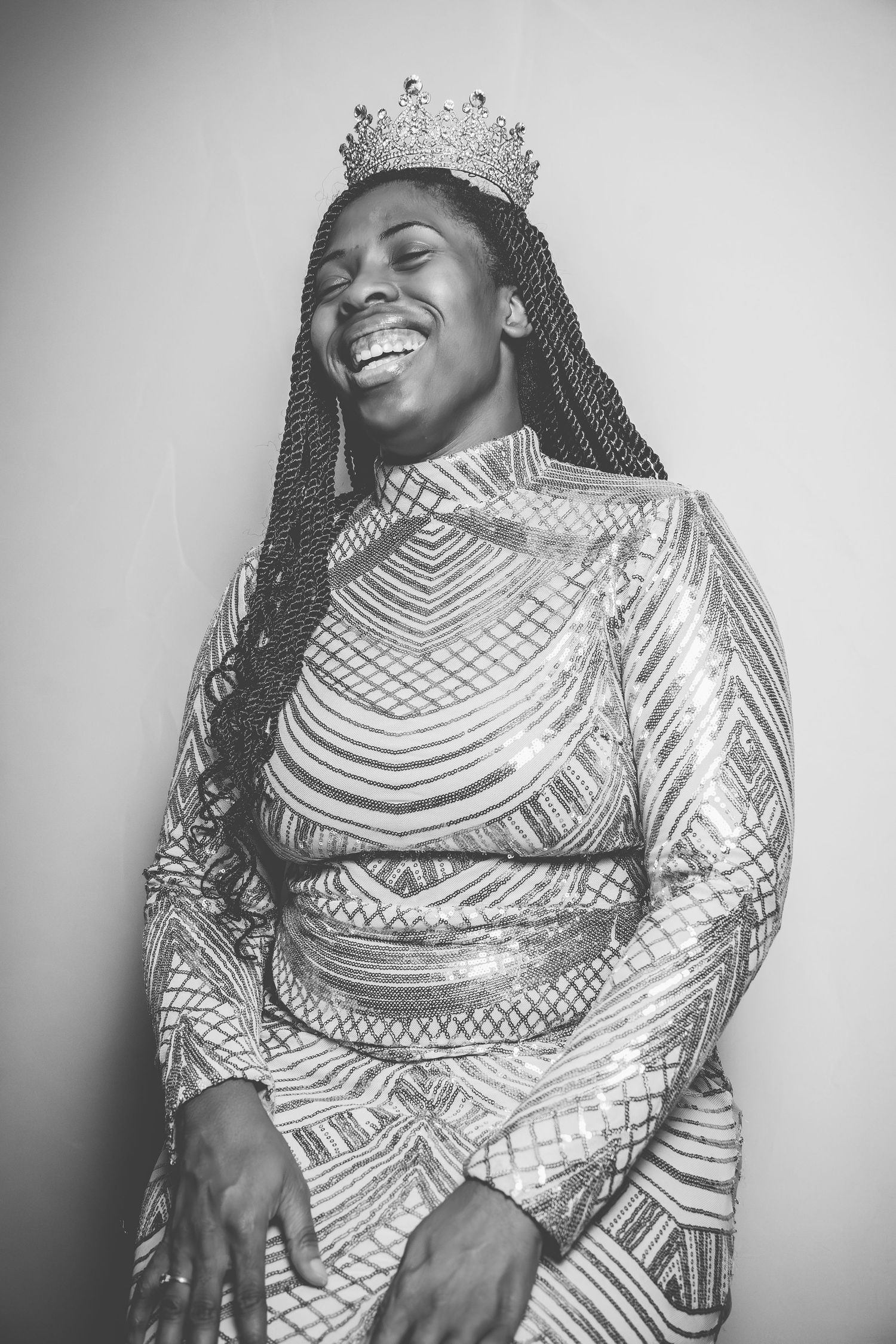 Black and white portrait series featuring poses in a shimmering geometric patterned formal gown.