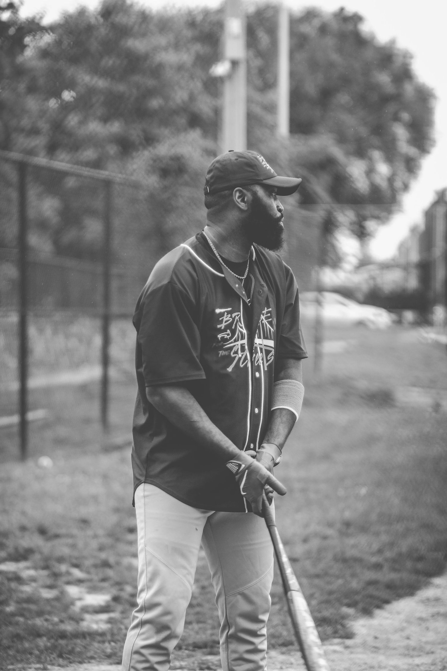 Black and white photo sequence showing a baseball player in a dark uniform preparing to field a ground ball.