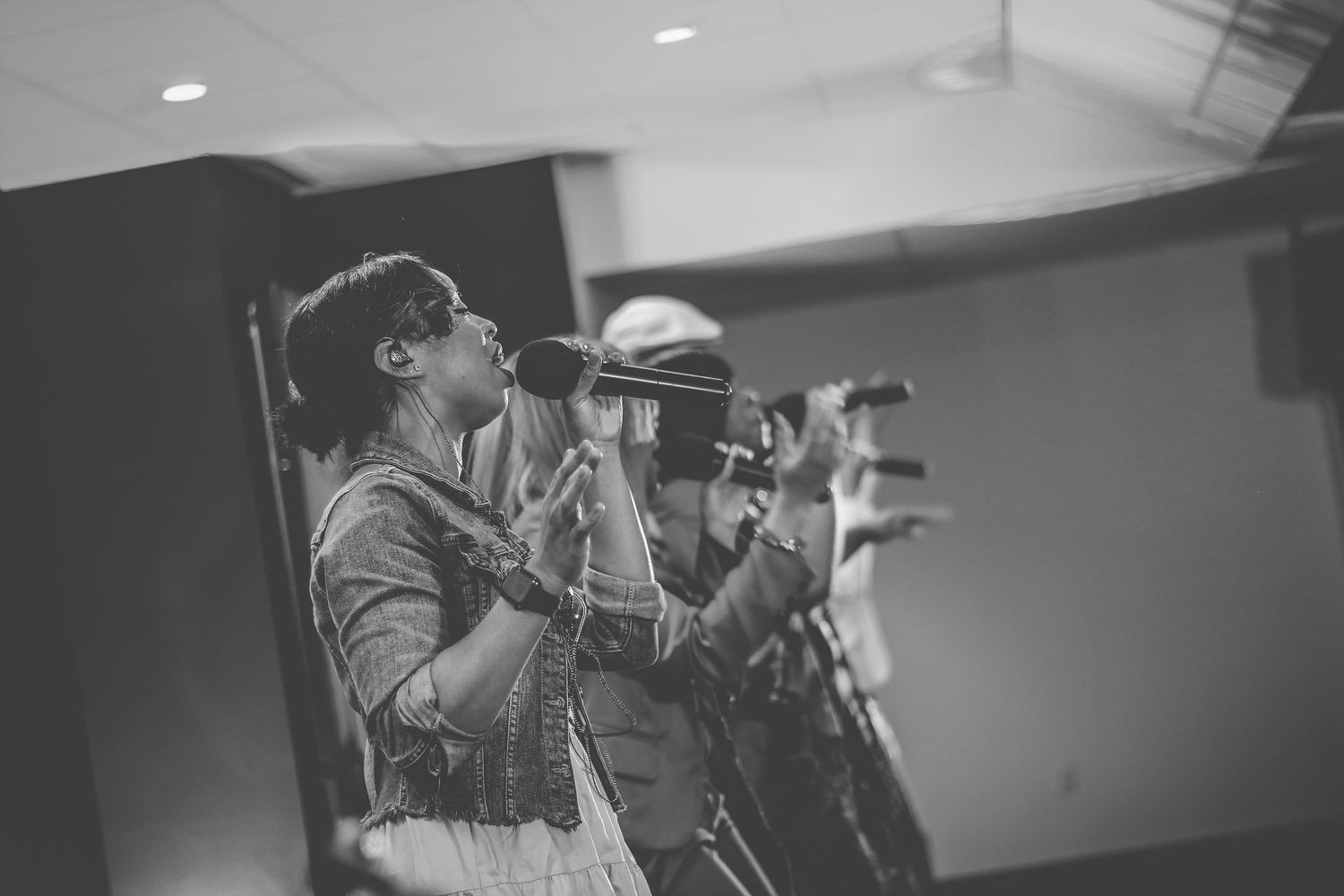 Black and white photo montage showing musicians performing on stage with microphones and instruments.