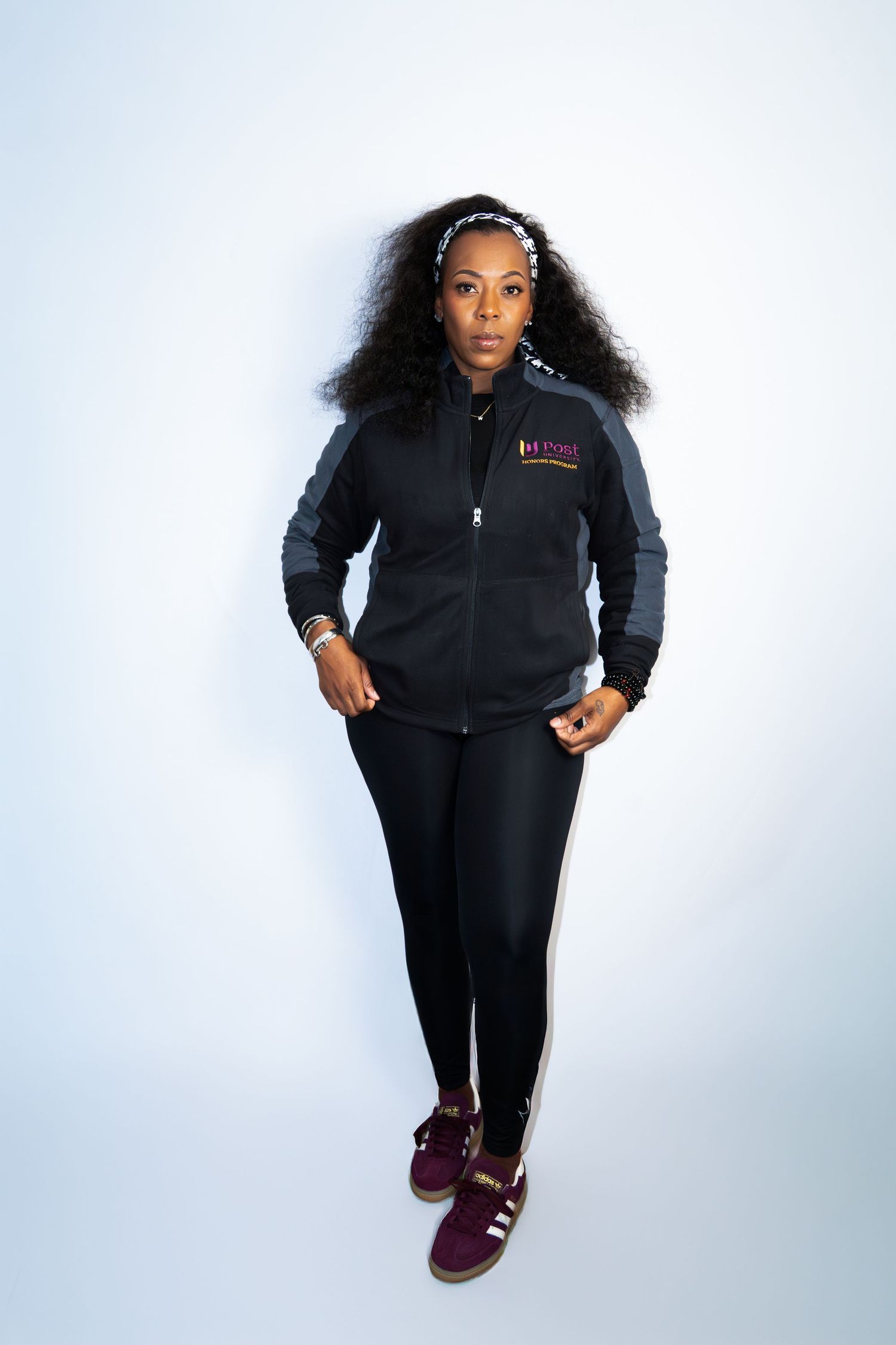 Athletic style photo series in black tracksuit outfit against white background showing dynamic movement.