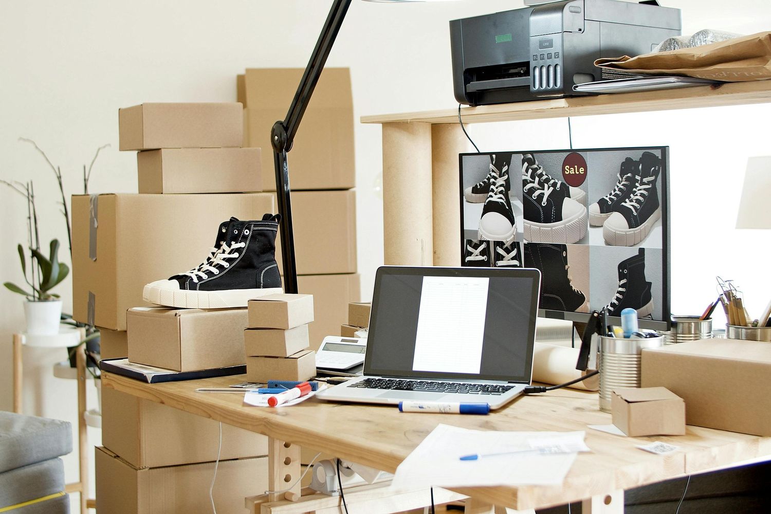 Moving boxes and office supplies arranged on desks in a modern workspace.