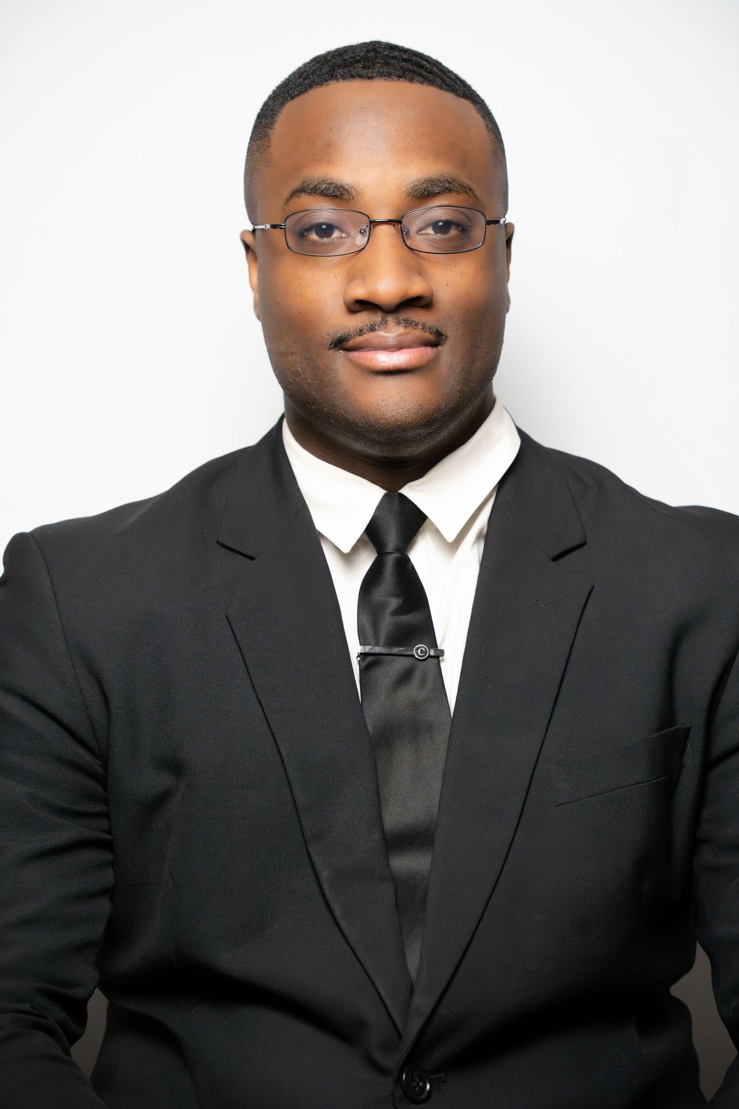 Business portrait series showing different angles in formal attire against white backdrop.