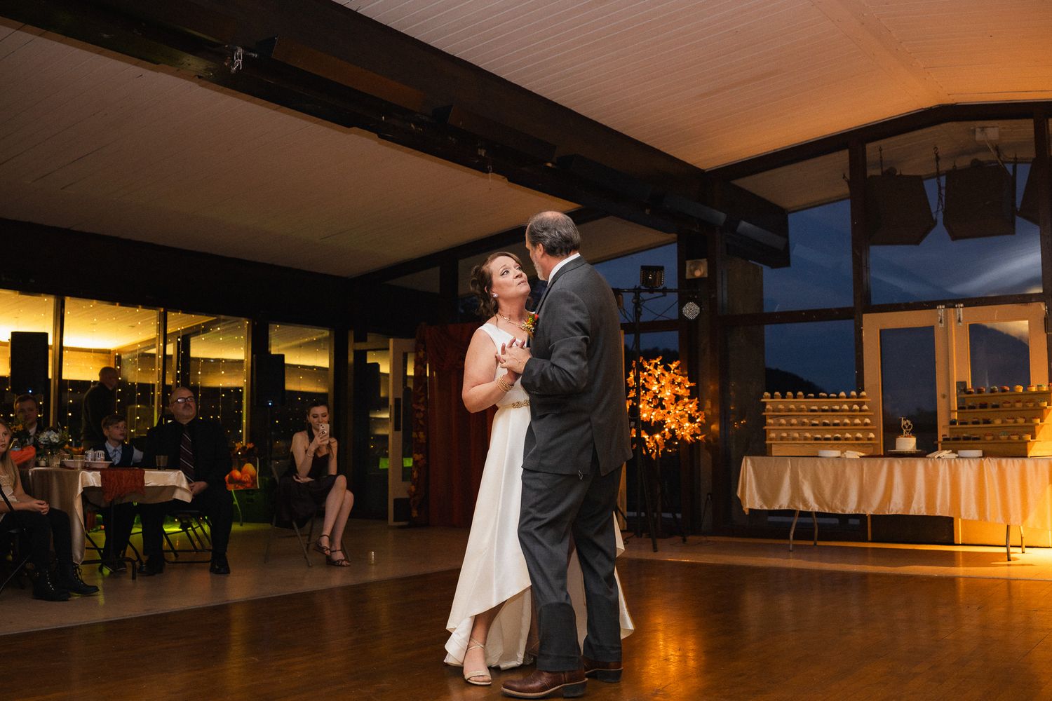 Bride and groom sharing their first dance at a romantic wedding reception in an elegant venue.