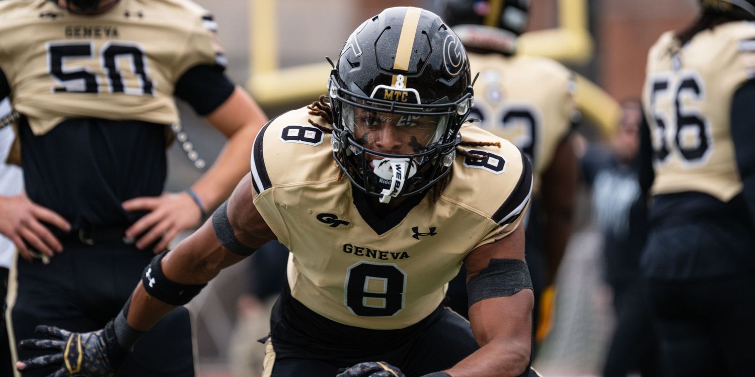 Geneva College football player number 8 in gold uniform charges onto field with intensity.