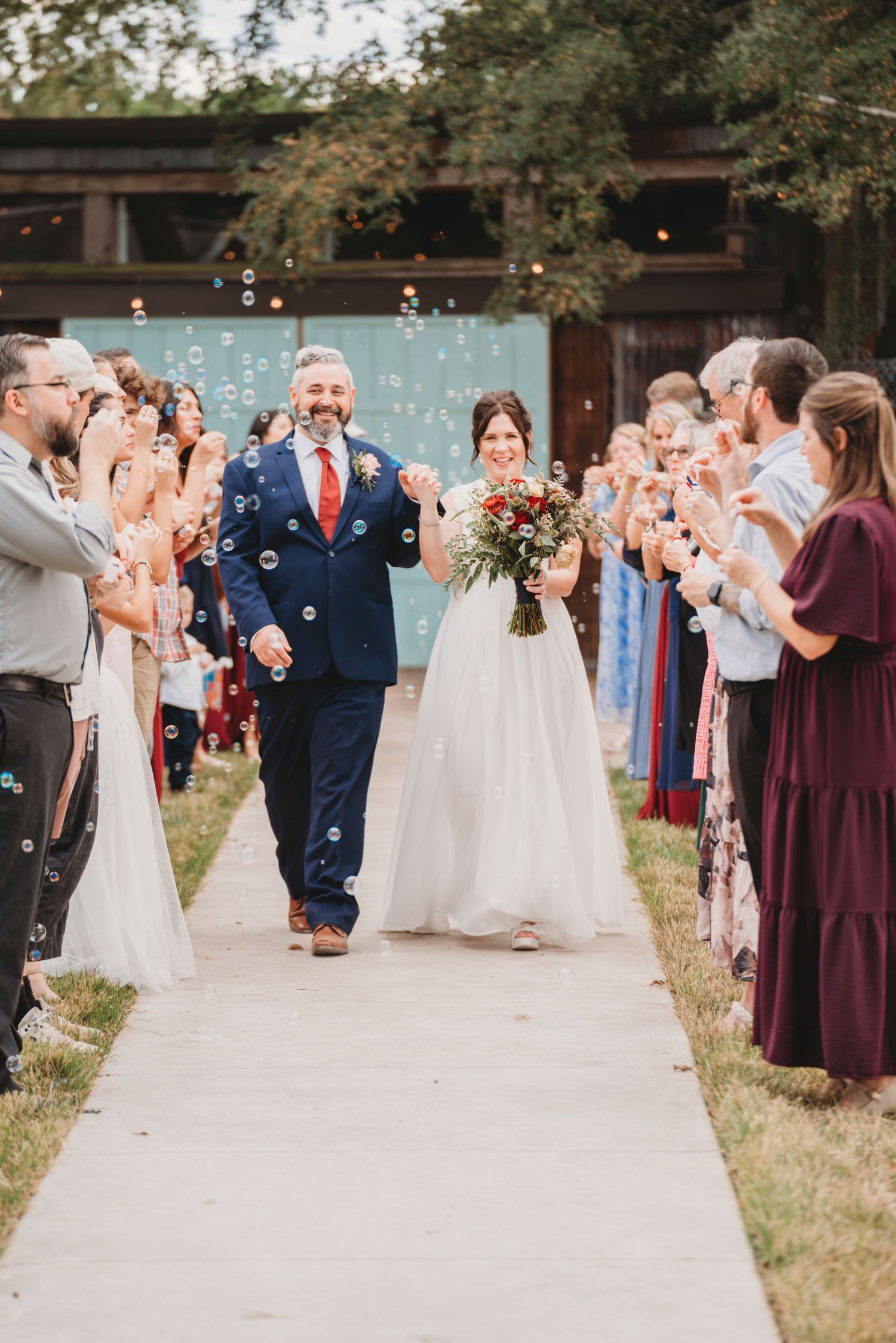 Bride and groom walking aisle recessional wedding exit Waco TX Sudden Joy Visuals