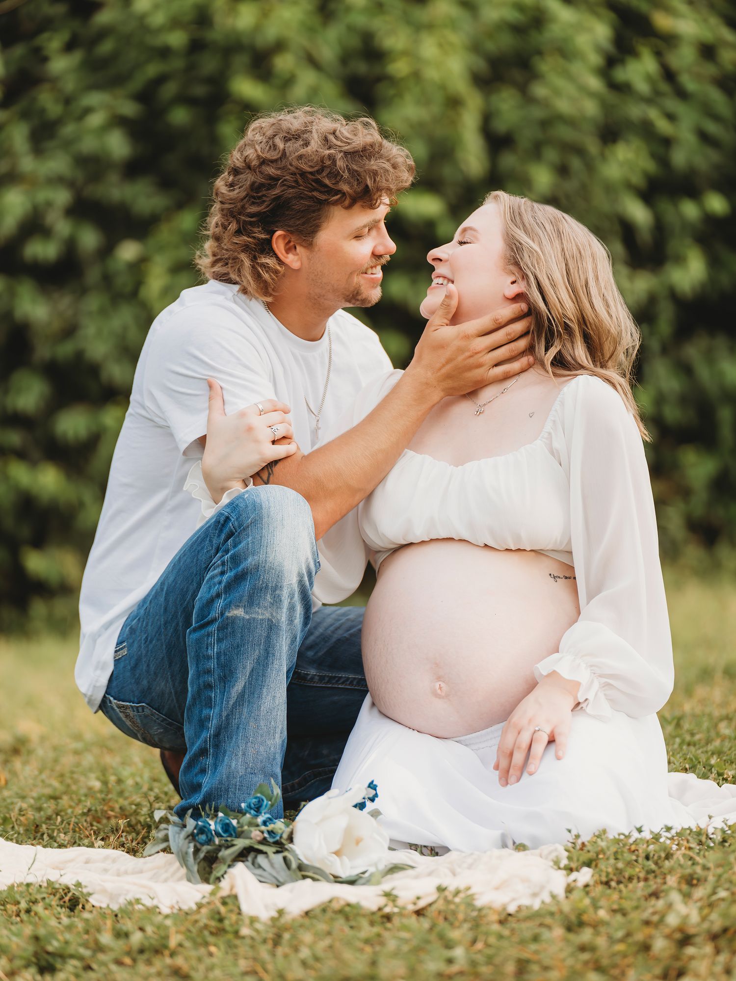 Maternity couple sitting together outdoor portrait Waco TX Sudden Joy Visuals