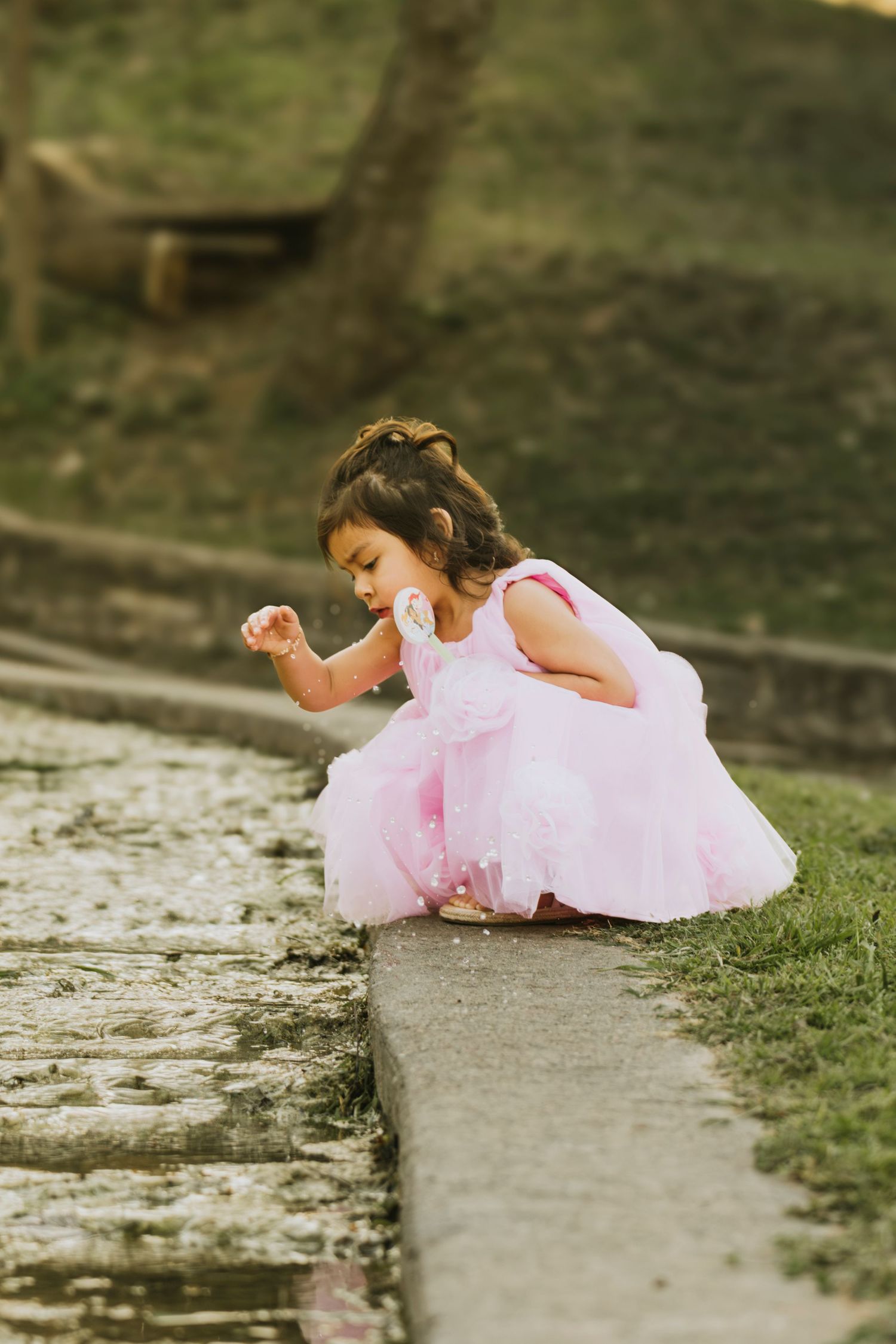 toddler girl by the creekside in pink dress Waco TX Sudden Joy Visuals