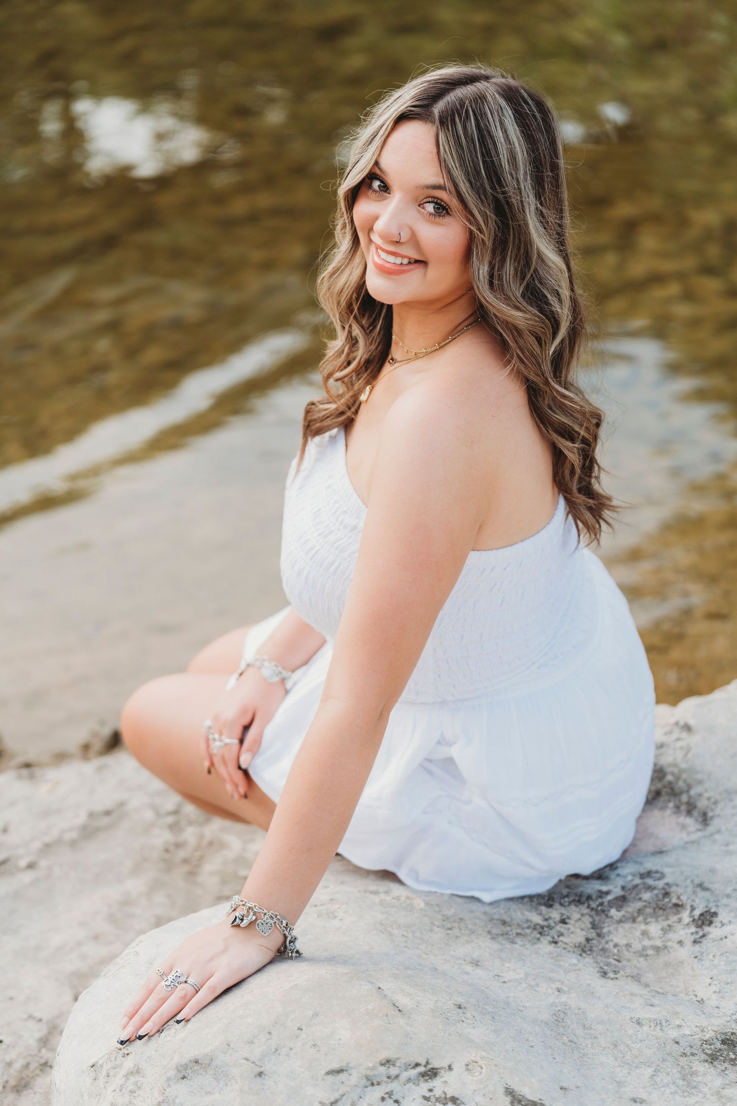 High School senior girl by the creekside in white dress Waco TX Sudden Joy Visuals
